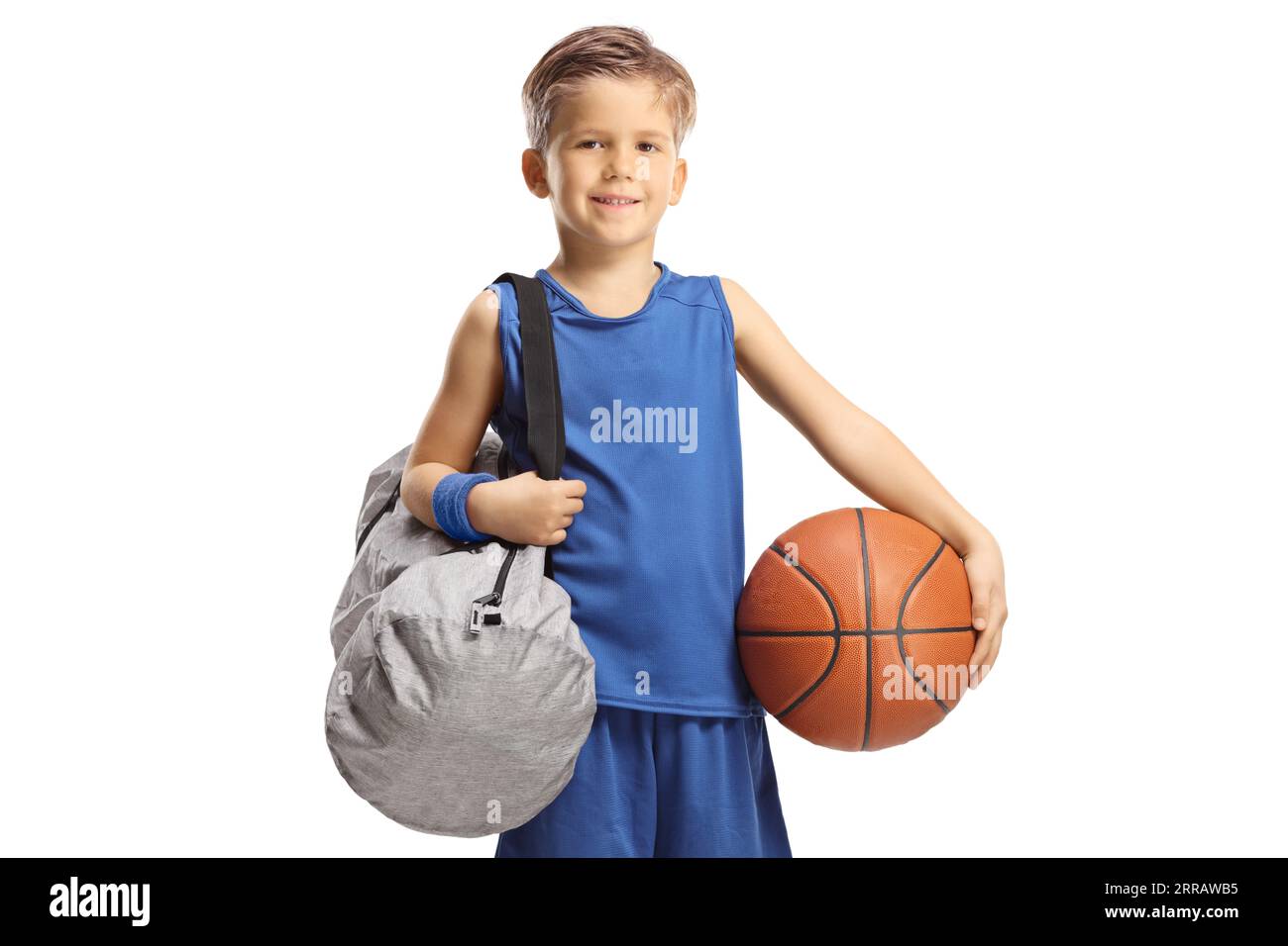 Boy with basketball carrying a sports bag isolated on white background
