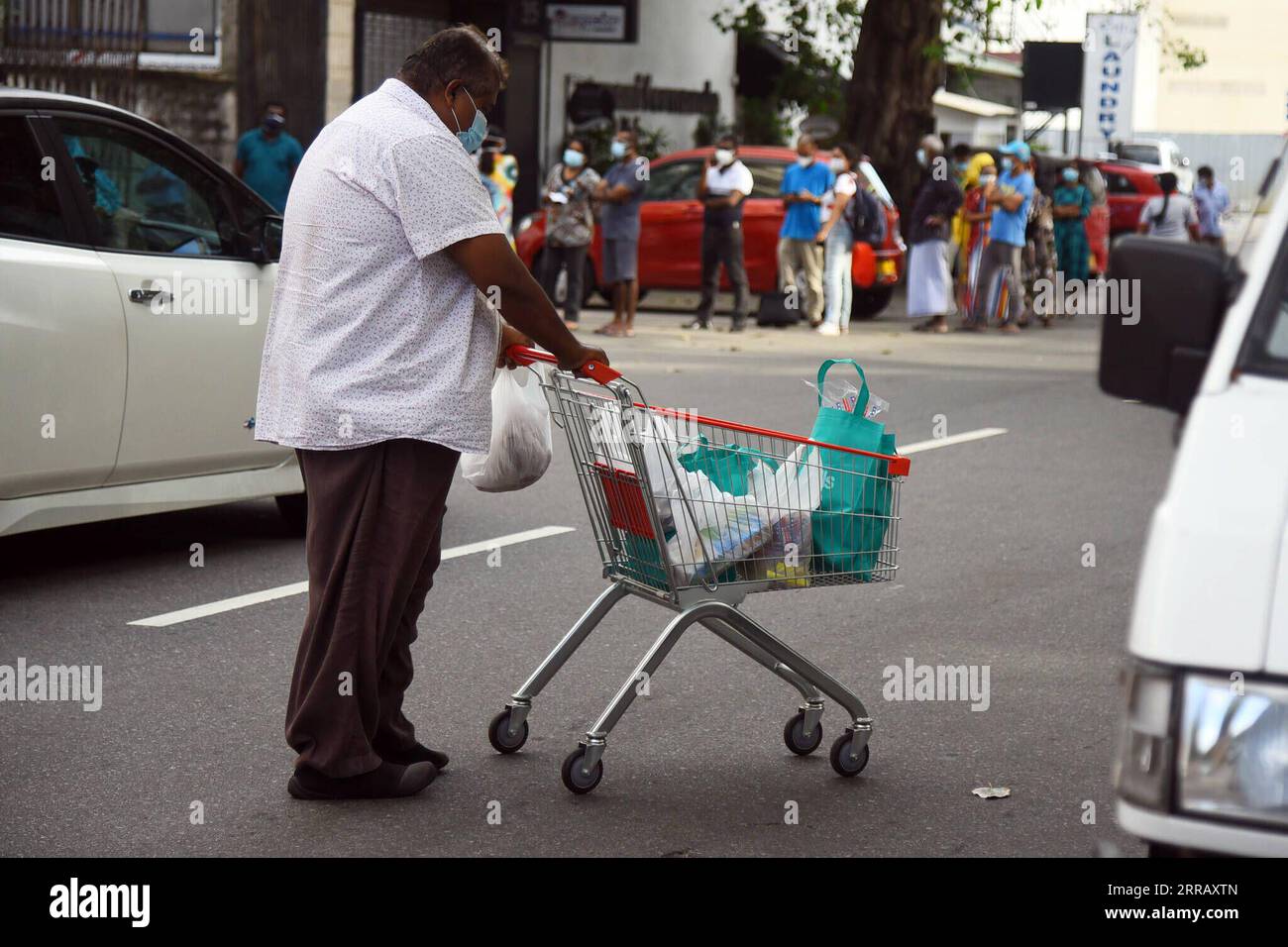 210820 -- COLOMBO, Aug. 20, 2021 -- A man pushes a cart with essential goods after Sri Lankan authority announced a 10-day nationwide quarantine curfew, in Colombo, Sri Lanka, on Aug. 20, 2021. A 10-day nationwide quarantine curfew will be imposed in Sri Lanka from Friday night in order to prevent a further spread of the COVID-19 virus, the country s Army Commander and Head of the National Operations Center for Prevention of COVID-19 Outbreak, General Shavendra Silva said on Friday. Photo by /Xinhua SRI LANKA-COLOMBO-COVID-19-QUARANTINE CURFEW-PREPARATION GayanxSameera PUBLICATIONxNOTxINxCHN Stock Photo