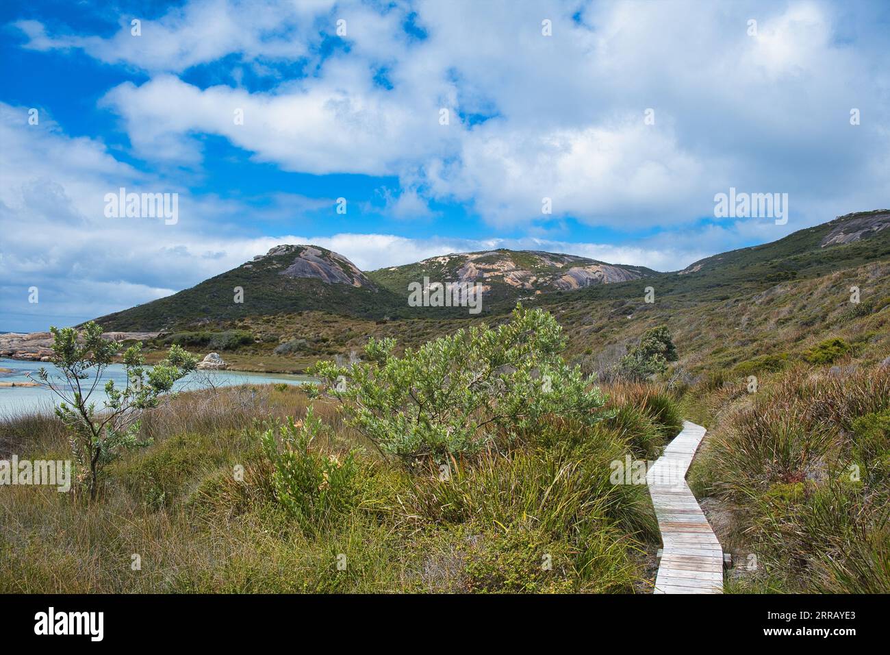 Wooden walkway through a saltwater marsh in Two Peoples Bay Nature Reserve, close to Albany, Western Australia. Granite headland in the background. Stock Photo