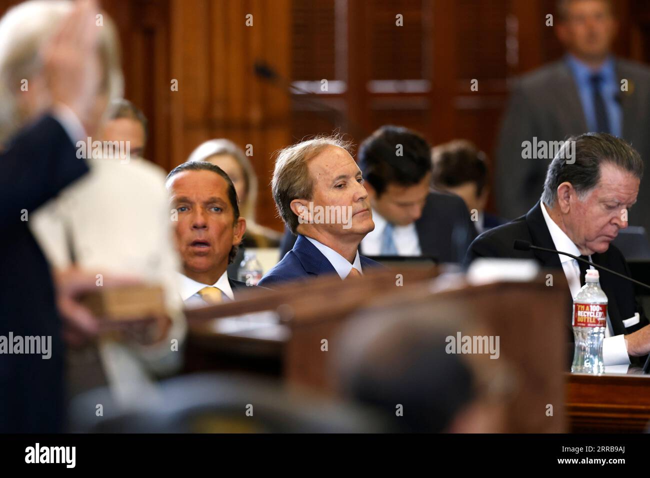 Texas Attorney General Ken Paxton (center) sits next to attorneys Tony Buzbee (center left) and Dan Cogdell (right) as Texas Sen. Robert Nichols (left), R-Jacksonville, is sworn in during the first day of Paxton’s impeachment trial in the Texas Senate chambers at the Texas State Capitol in Austin on Tuesday, Sept. 5, 2023. The Texas House, including a majority of its GOP members, voted to impeach Paxton for alleged corruption in May. (Juan Figueroa/Pool via The Dallas Morning News) Stock Photo