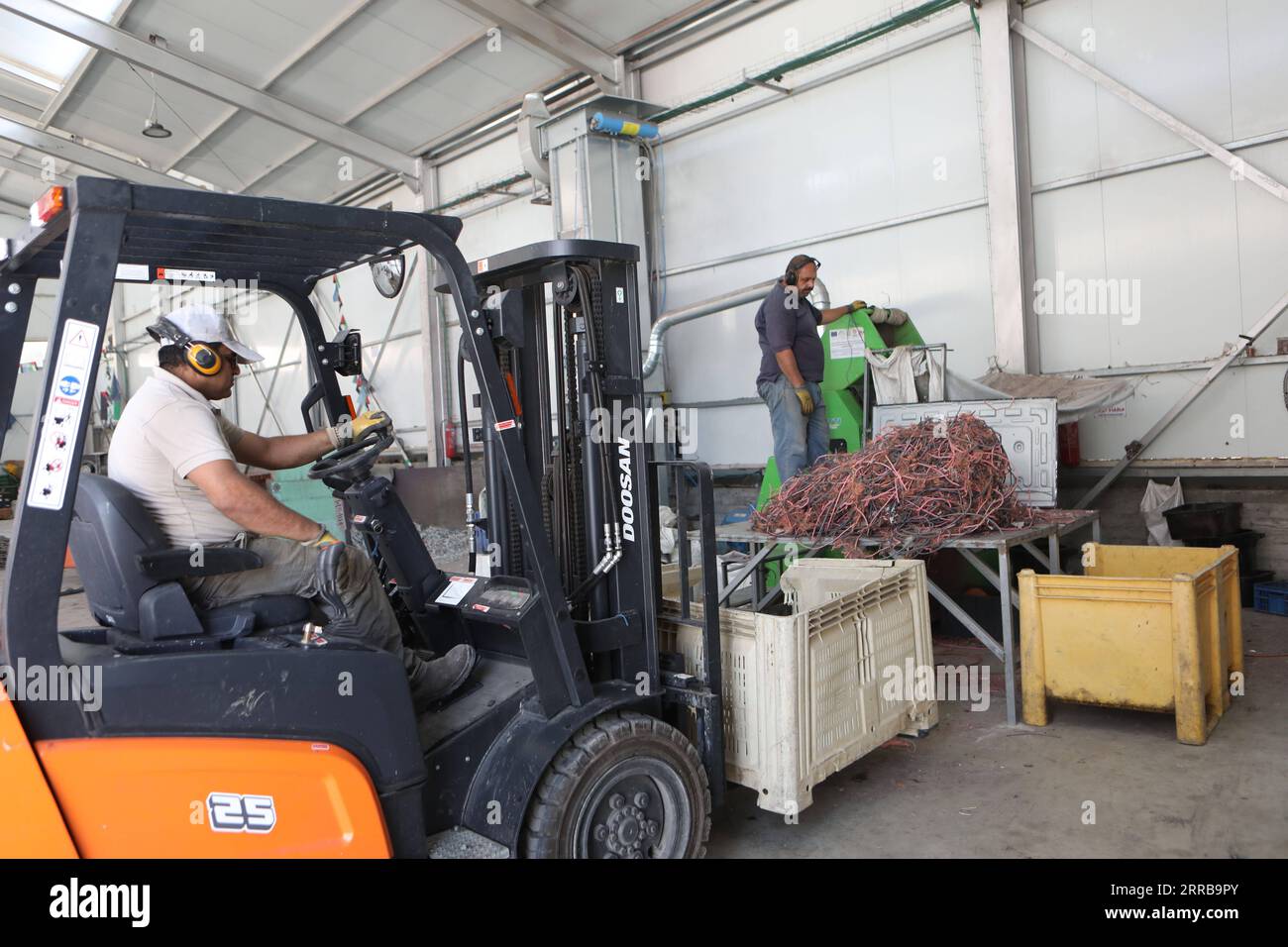 210910 HEBRON, Sept. 10, 2021 Workers are seen at an electronic