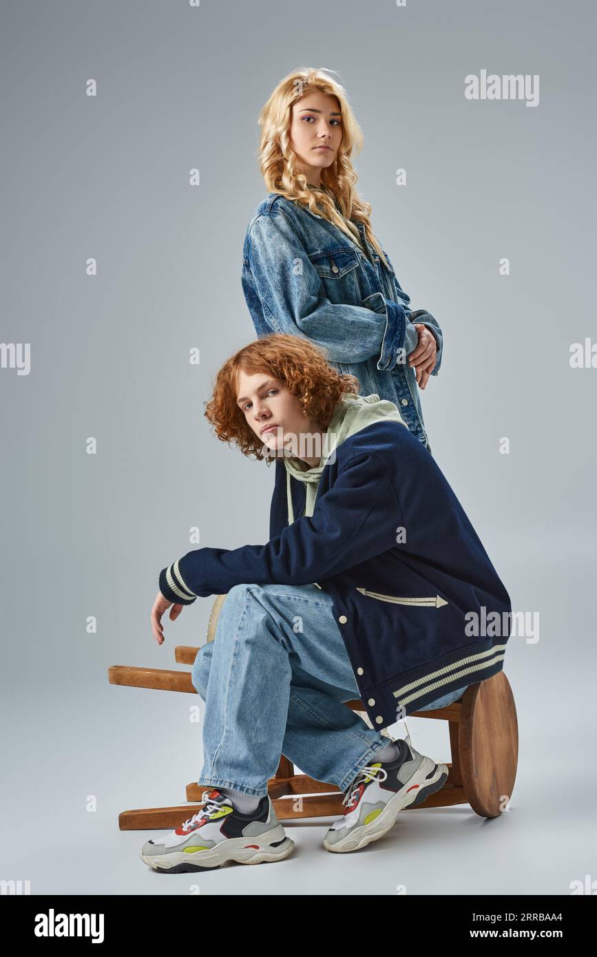 youthful couple in fashionable casual clothes looking at camera