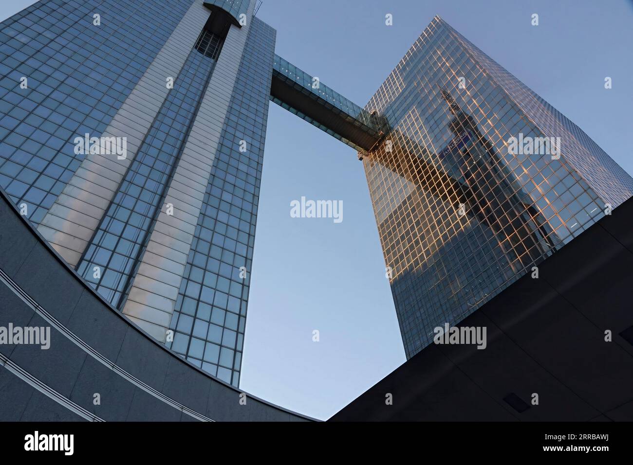 Upward wide-angle closeup on the Proximus Belgacom twin tower skyscraper against a blue sunny sky Stock Photo