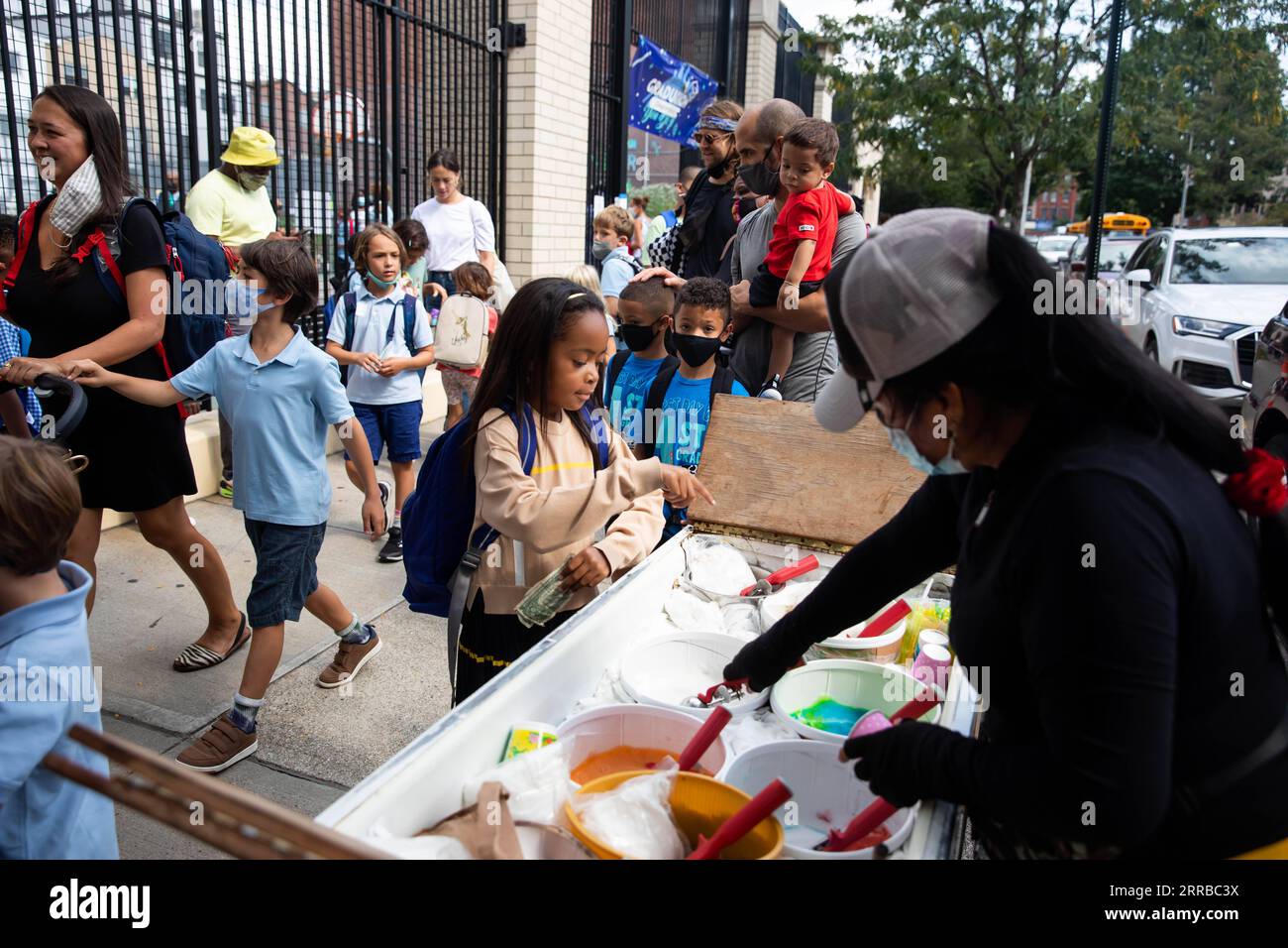 210914 -- NEW YORK, Sept. 14, 2021 -- A student buys ice cream after the first day of school at PS 133 in the Brooklyn borough of New York, the United States, on Sept. 13, 2021. The public schools in New York City started a new school year with full in-person teaching and learning on Monday as many parents and teachers are still calling for an on-line option. The public school system in New York City, the biggest one in the United States with about 1.1 million students, saw the return of most of its students with joy and anxiety. Photo by /Xinhua U.S.-NEW YORK-SCHOOL-REOPENING MichaelxNagle PU Stock Photo