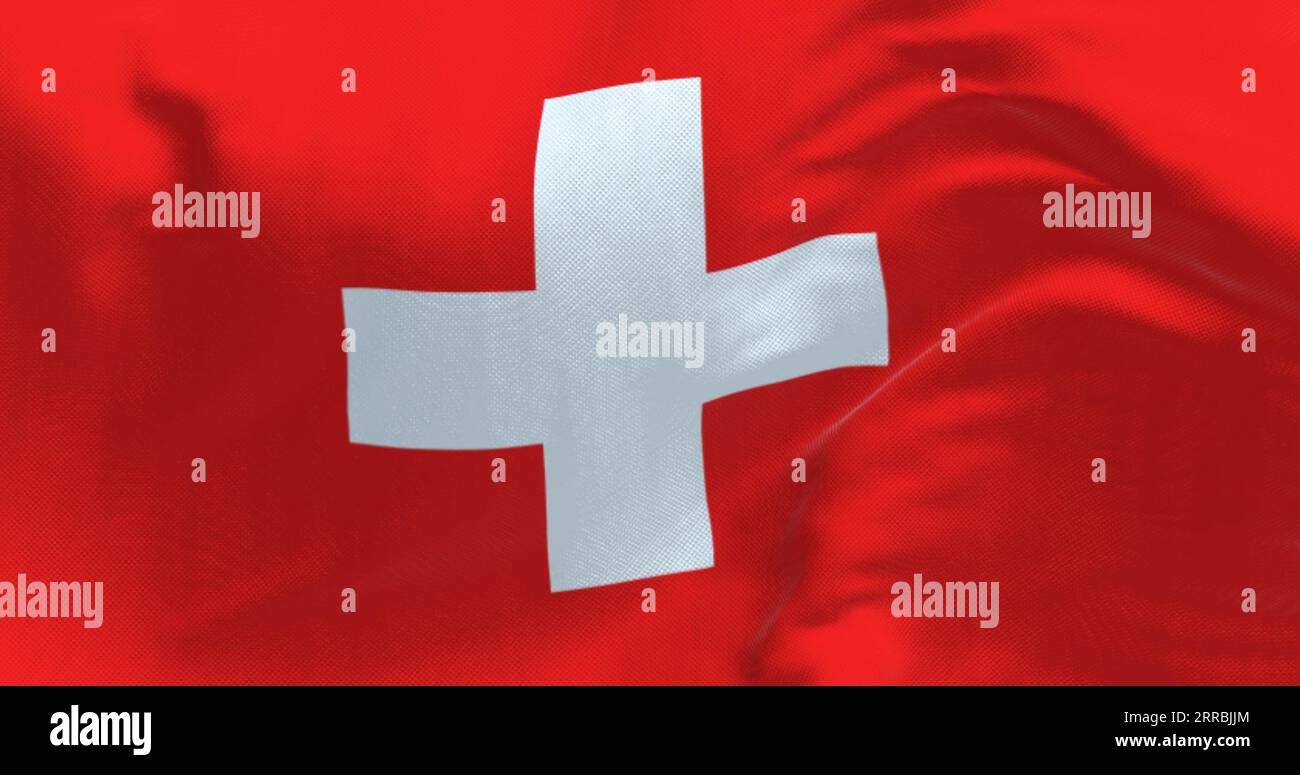 Close-up view of Switzerland national flag waving in the wind. Red background with a white cross in the center. 3d illustration render. Fluttering fab Stock Photo