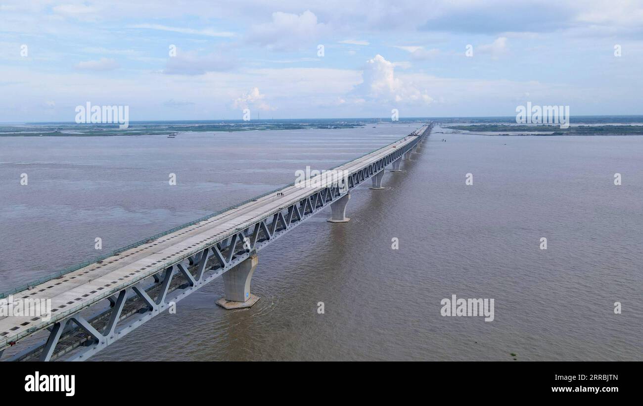 210926 -- MUNSHIGANJ, Sept. 26, 2021 -- Aerial photo taken on Aug. 27, 2021 shows a view of Padma Multipurpose Bridge Project under construction in Munshiganj on the outskirts of Dhaka, Bangladesh. For Bangladeshis, a dream is coming true. The history of crossing the mighty Padma river between dozens of districts in southern Bangladesh and the capital of Dhaka only by ferries or boats is all set to end. The mega multipurpose road-rail bridge dubbed the Dream Padma Bridge of Bangladesh is nearing completion after workers overcame tons of hurdles, including challenges brought by the COVID-19 pan Stock Photo