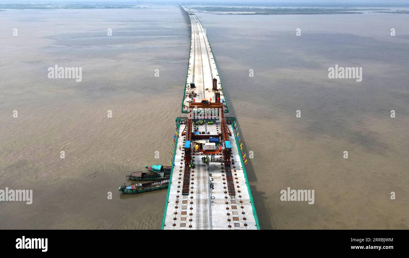 210926 -- MUNSHIGANJ, Sept. 26, 2021 -- Aerial photo taken on Aug. 24, 2021 shows a construction site of Padma Multipurpose Bridge Project in Munshiganj on the outskirts of Dhaka, Bangladesh. For Bangladeshis, a dream is coming true. The history of crossing the mighty Padma river between dozens of districts in southern Bangladesh and the capital of Dhaka only by ferries or boats is all set to end. The mega multipurpose road-rail bridge dubbed the Dream Padma Bridge of Bangladesh is nearing completion after workers overcame tons of hurdles, including challenges brought by the COVID-19 pandemic. Stock Photo