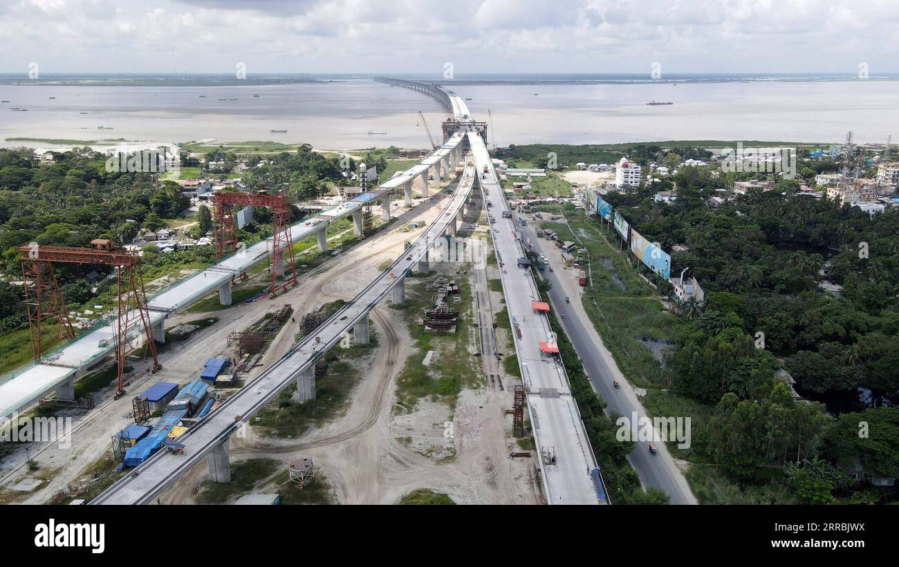 210926 -- MUNSHIGANJ, Sept. 26, 2021 -- Aerial photo taken on July 18, 2021 shows a construction site of Padma Multipurpose Bridge Project in Munshiganj on the outskirts of Dhaka, Bangladesh. For Bangladeshis, a dream is coming true. The history of crossing the mighty Padma river between dozens of districts in southern Bangladesh and the capital of Dhaka only by ferries or boats is all set to end. The mega multipurpose road-rail bridge dubbed the Dream Padma Bridge of Bangladesh is nearing completion after workers overcame tons of hurdles, including challenges brought by the COVID-19 pandemic. Stock Photo