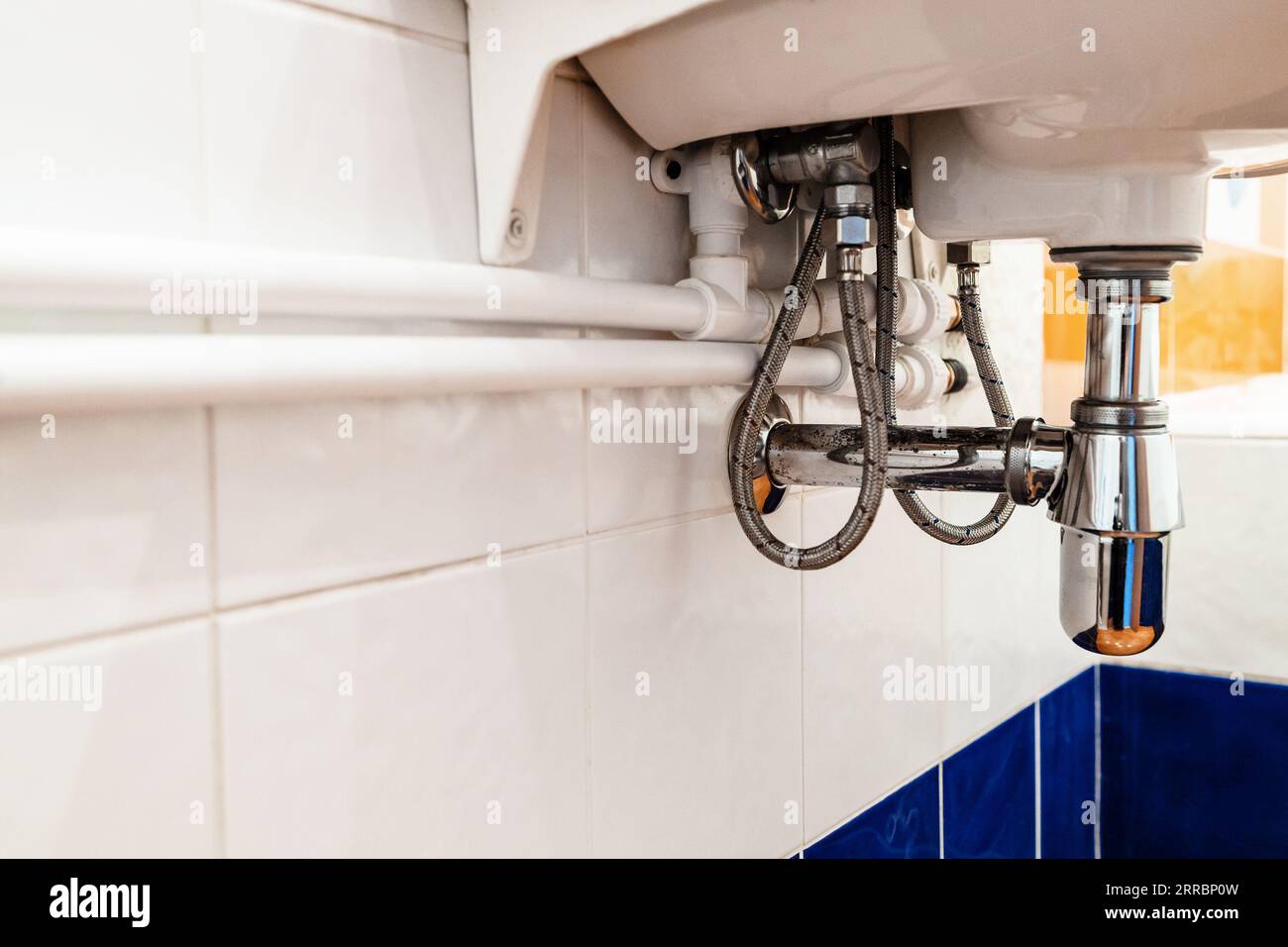 new white polypropylene pipes connect with faucet under sink in