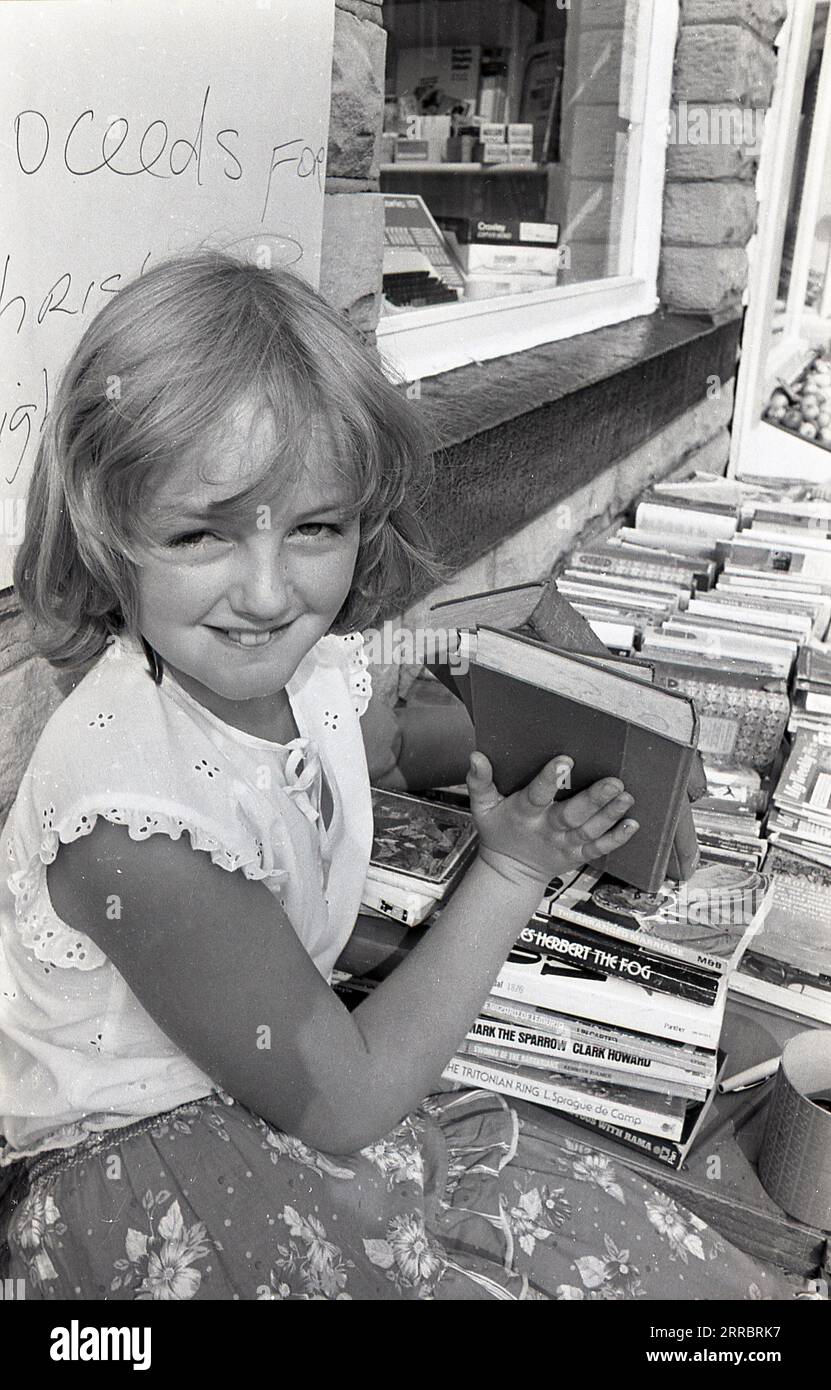 1983, historical, girl selling second hand books for christmas lights