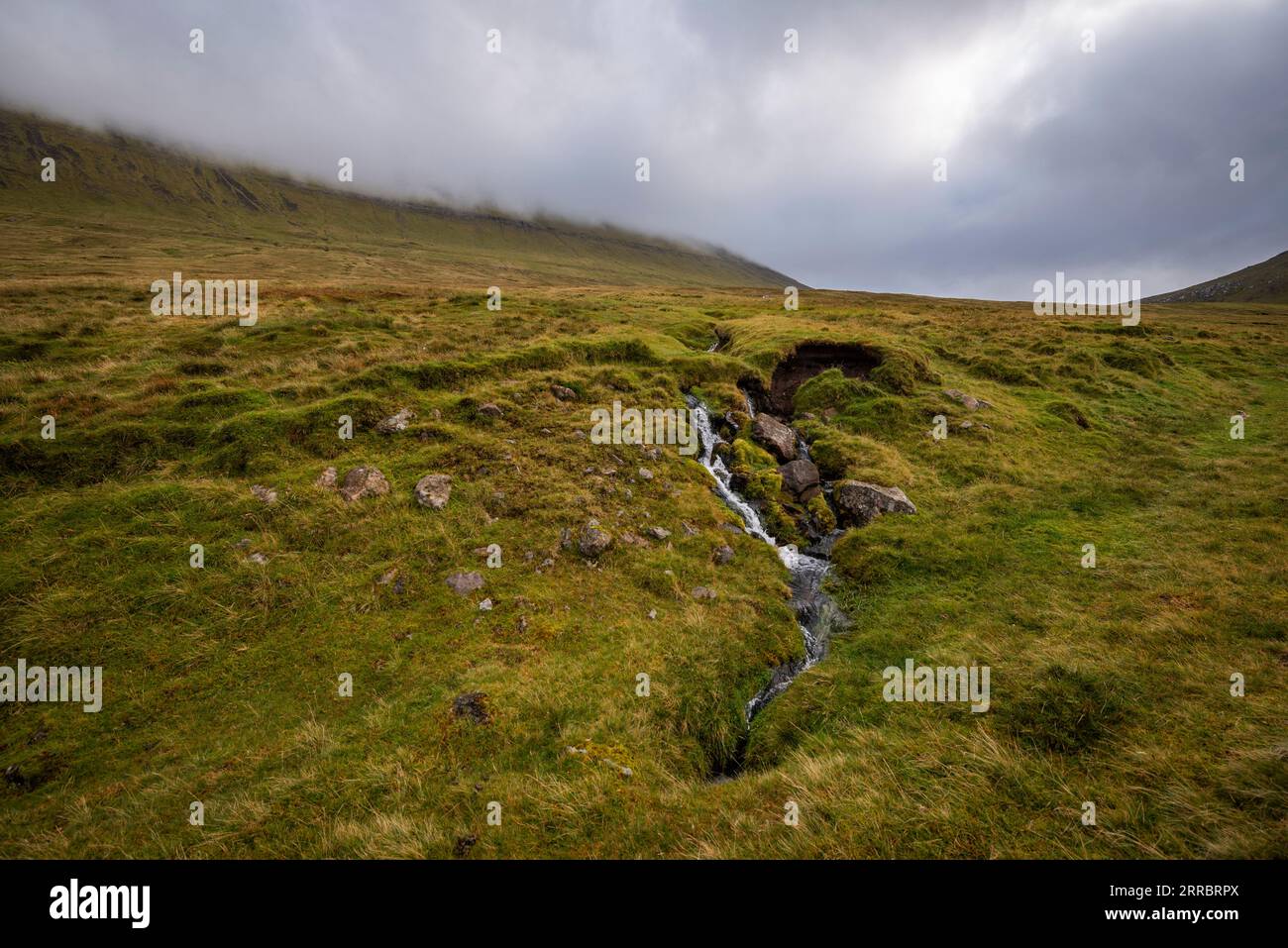 A small channel of water drains off the high plateau on Eysturoy island