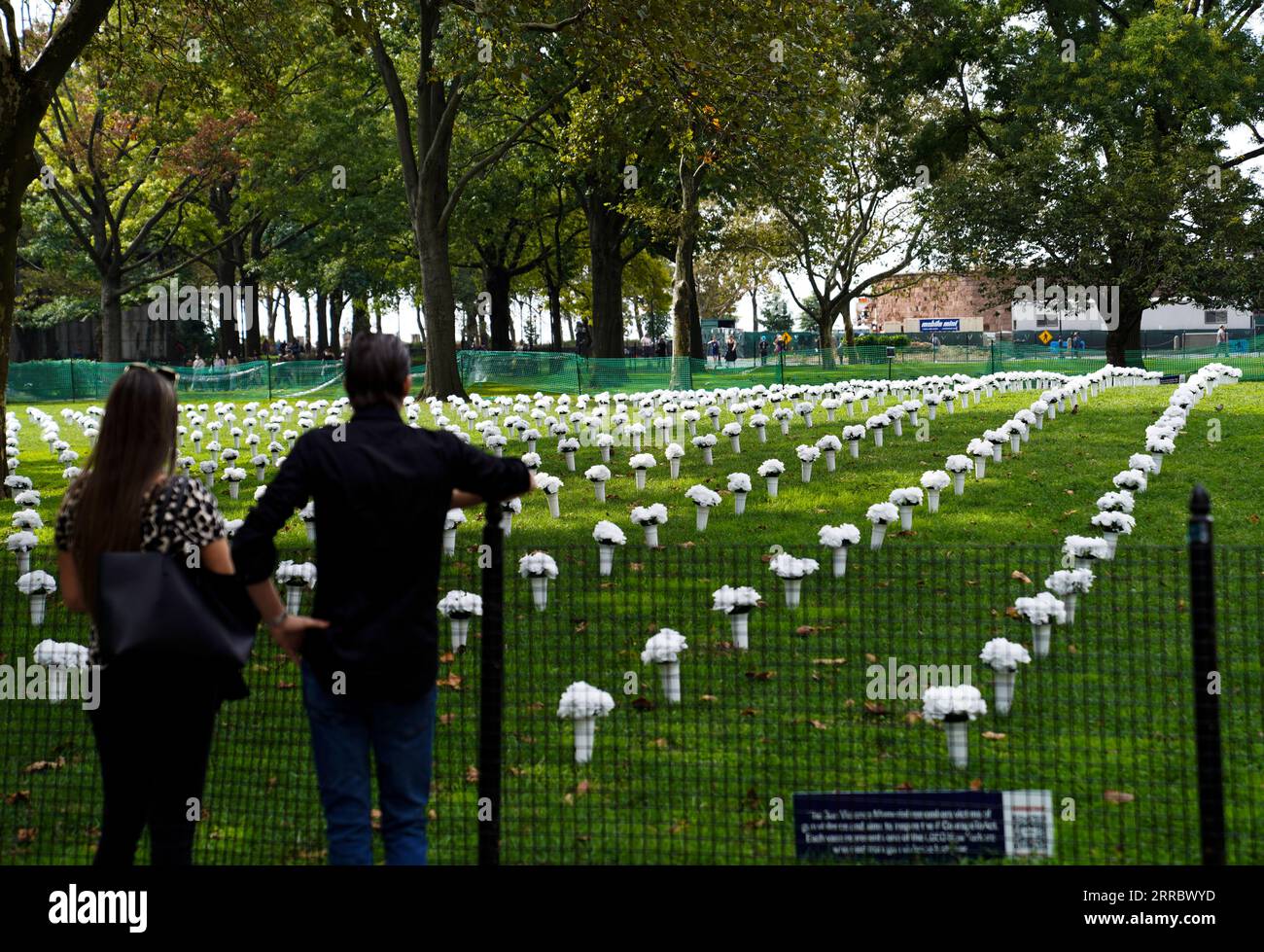 211009 NEW YORK, Oct. 9, 2021 People look at the vases of flowers