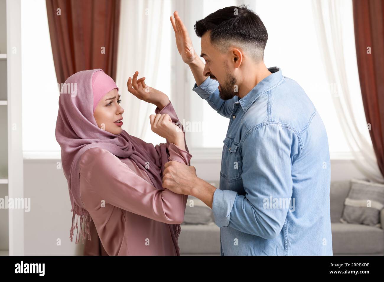 Angry Muslim man threatening his wife at home. Domestic violence concept  Stock Photo - Alamy