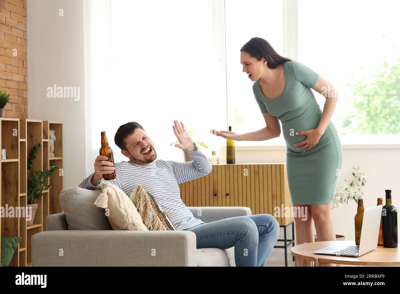 Drunk husband fighting with his pregnant wife at home. Domestic