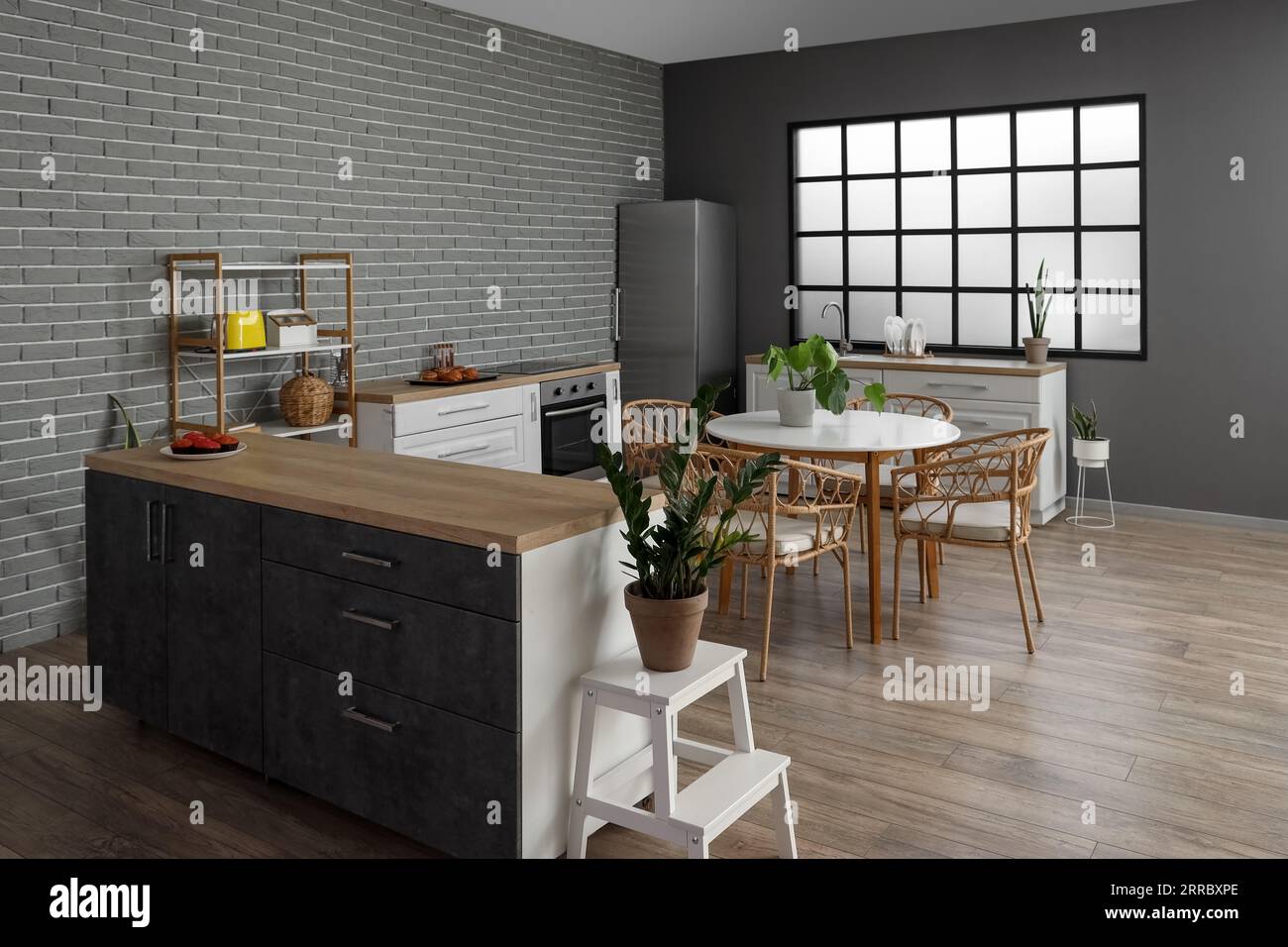 Interior of modern kitchen with dining table, houseplants and kitchen ...