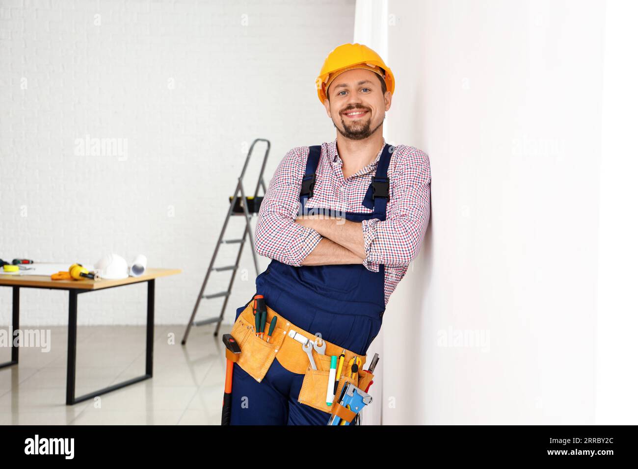 Male builder working in room Stock Photo - Alamy