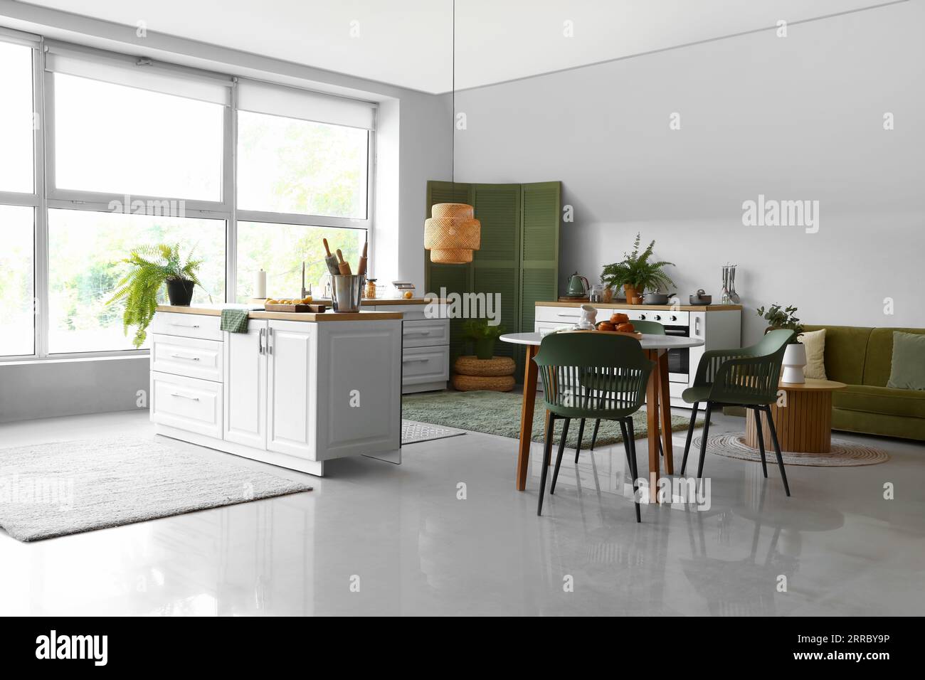 Interior of modern kitchen with white counters and dining table Stock ...