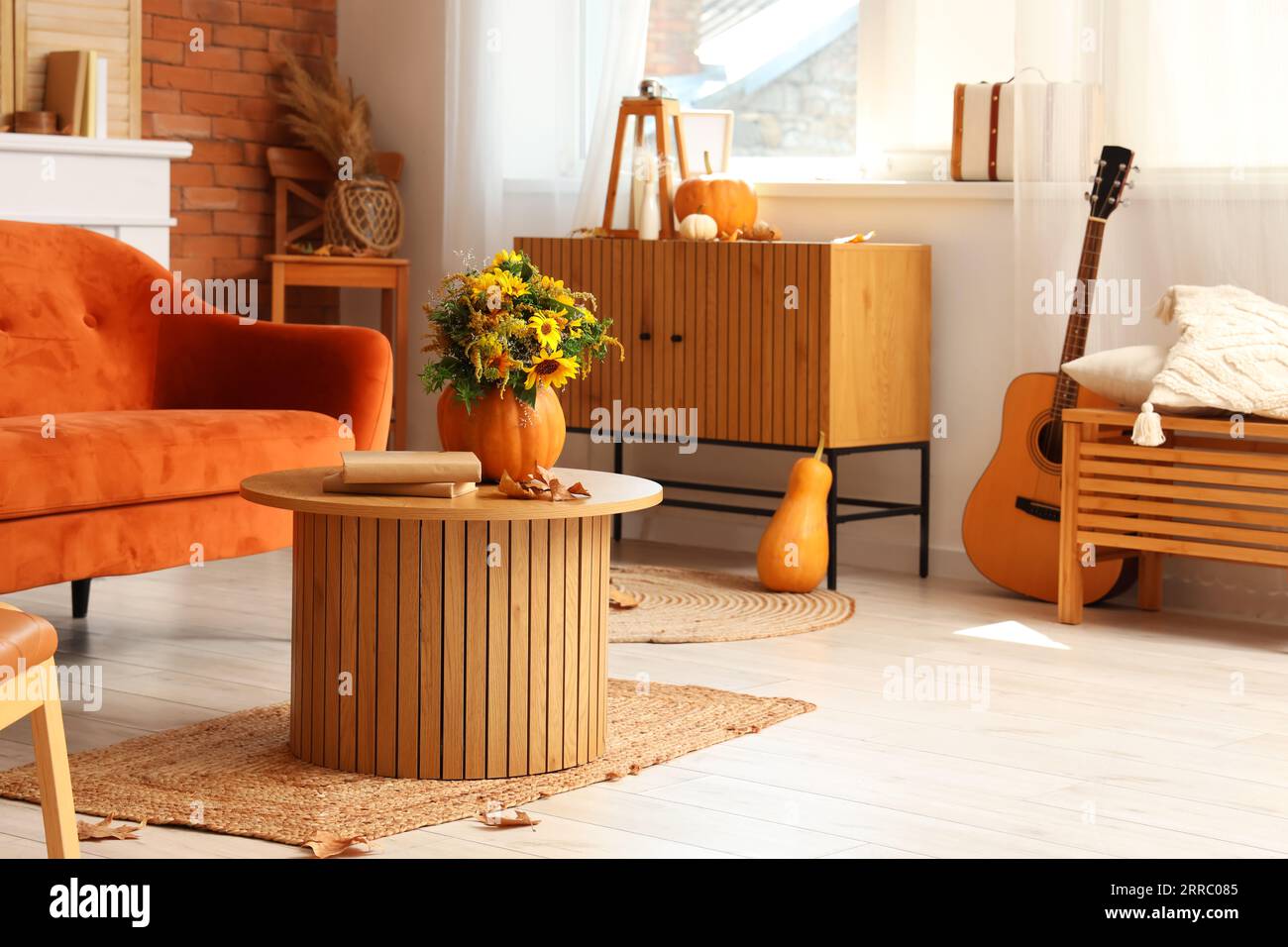 Interior of living room with pumpkins, sofa and table Stock Photo - Alamy
