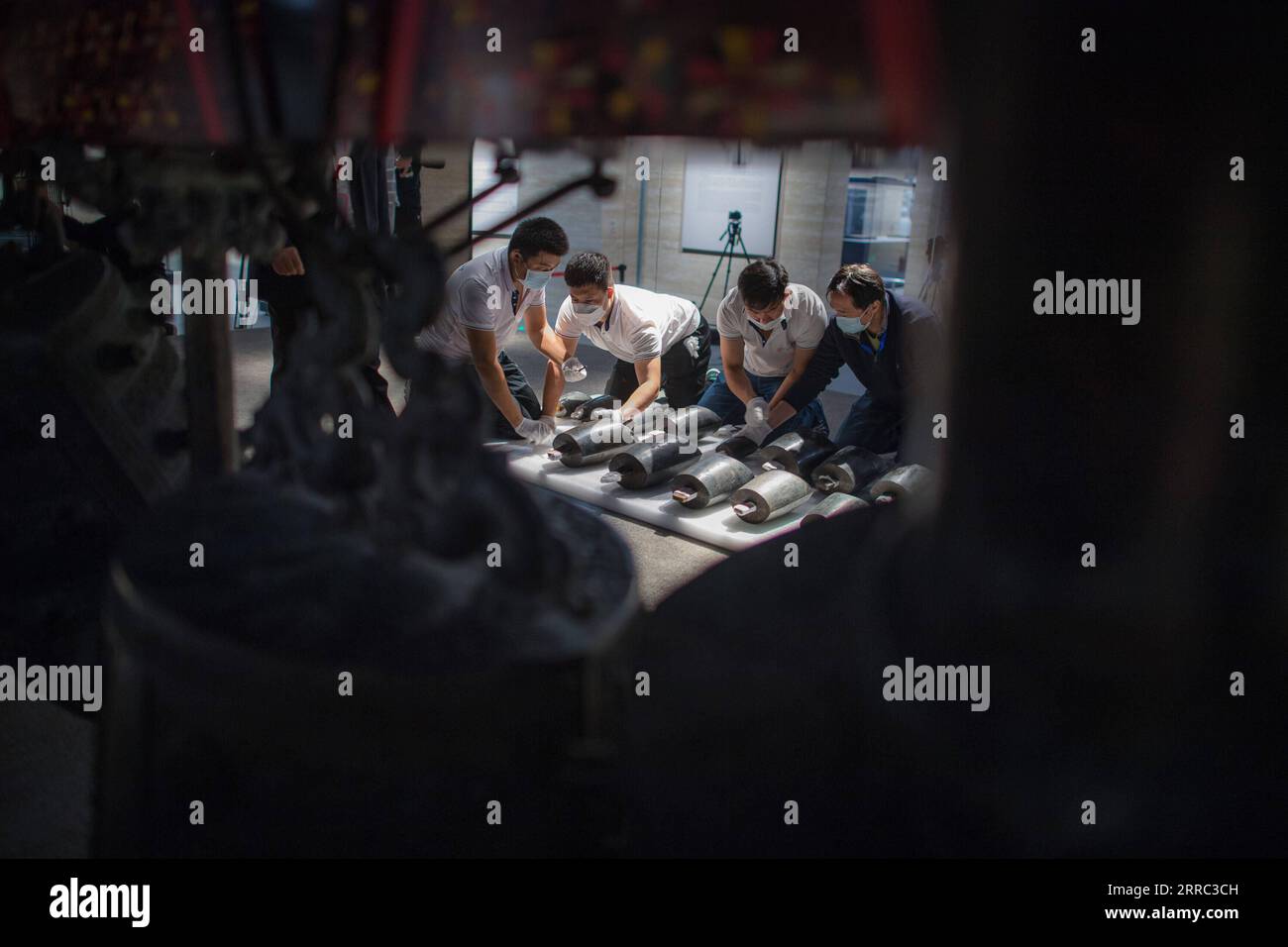 211015 -- WUHAN, Oct. 15, 2021 -- Staff members prepare to install chime bells after they were transferred to a newly-built exhibition hall of Hubei Provincial Museum in Wuhan, central China s Hubei Province, Oct. 15, 2021. The set of chime bells were recently relocated to the newly-built third phase project of the museum. Chime bell, or bian zhong in Chinese, is a percussion instrument that became prevalent in China from the Western Zhou Dynasty 1046-771 B.C.. The country s largest set of chime bells ever unearthed was found in 1978, also in Suizhou, in the tomb of Marquis Yi, a ruler of the Stock Photo