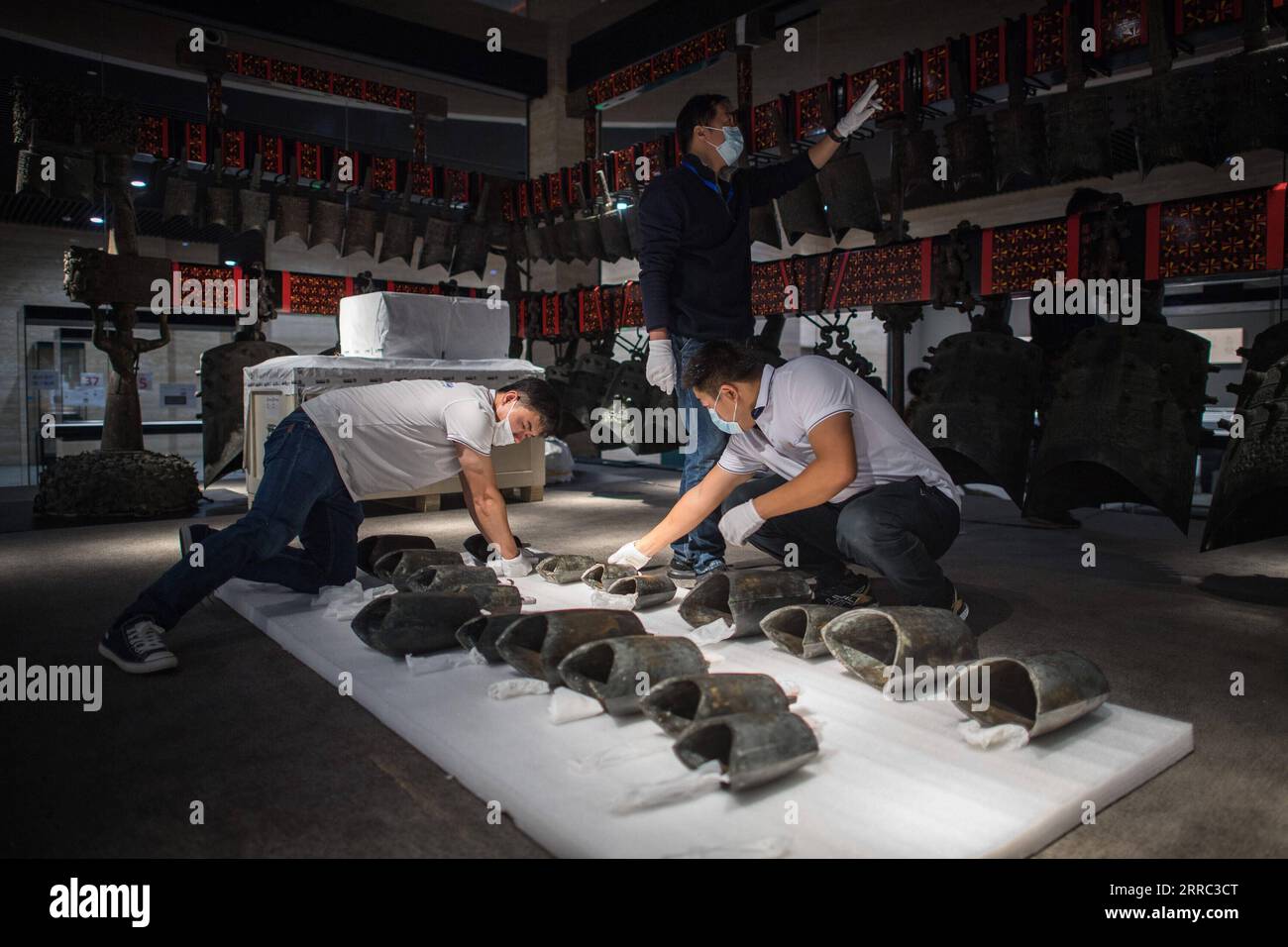 211015 -- WUHAN, Oct. 15, 2021 -- Staff members prepare to install chime bells after they were transferred to a newly-built exhibition hall of Hubei Provincial Museum in Wuhan, central China s Hubei Province, Oct. 15, 2021. The set of chime bells were recently relocated to the newly-built third phase project of the museum. Chime bell, or bian zhong in Chinese, is a percussion instrument that became prevalent in China from the Western Zhou Dynasty 1046-771 B.C.. The country s largest set of chime bells ever unearthed was found in 1978, also in Suizhou, in the tomb of Marquis Yi, a ruler of the Stock Photo