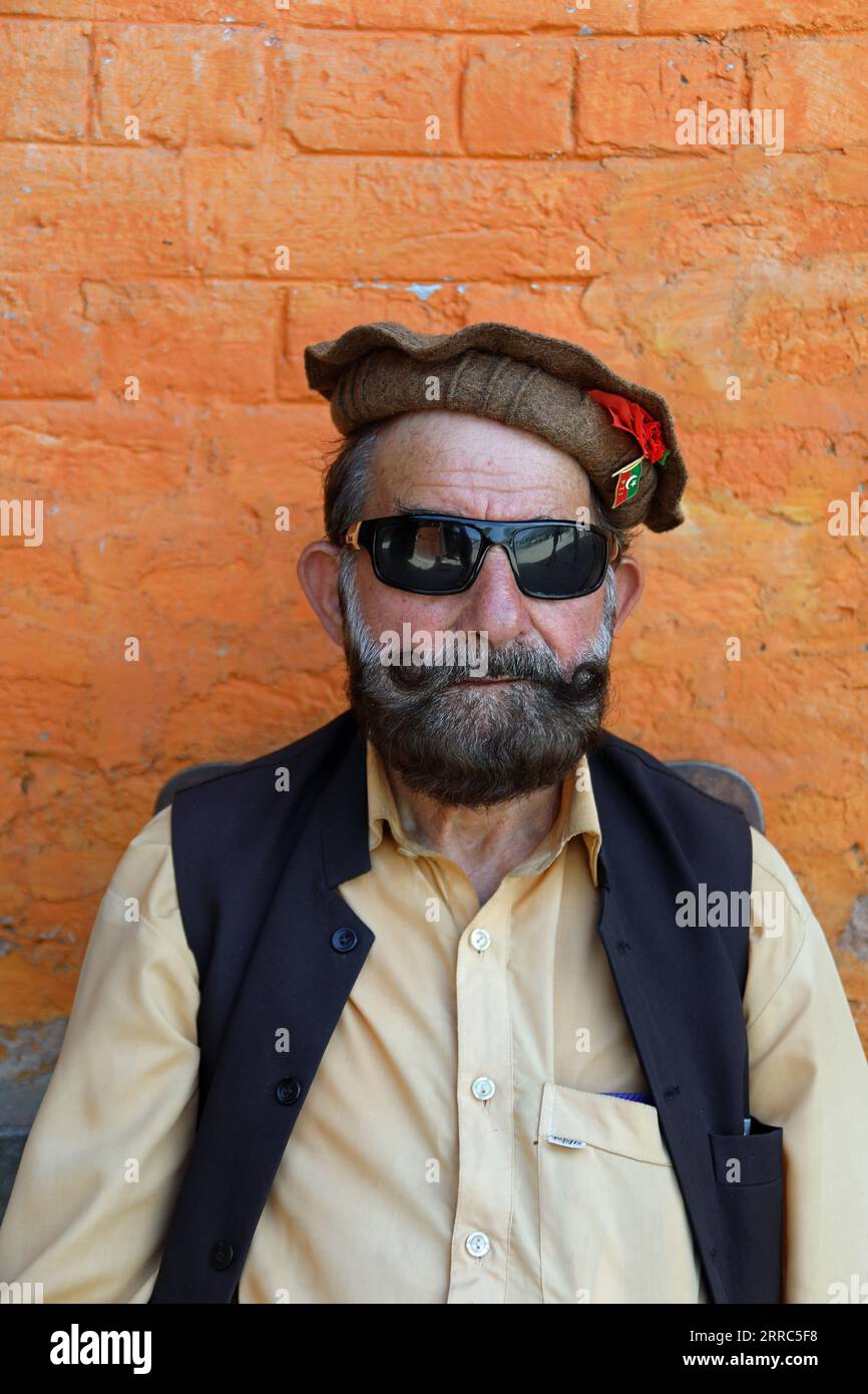 Pakistani gatekeeper at Chitral Fort wearing a P T I badge Stock Photo