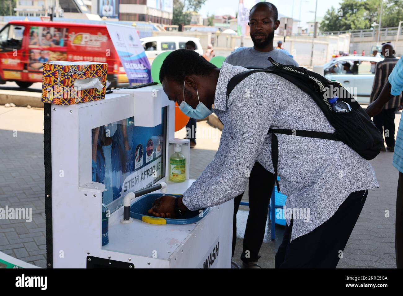 211019 -- ACCRA, Oct. 19, 2021 -- A man uses a handwashing facility to wash his hands in Accra, Ghana, on Oct. 15, 2021. The ongoing COVID-19 pandemic that lasted for more than a year in Ghana has not only prompted citizens to care more about their hand hygiene, but spurred local inventors to come up with more creative ways to cater to people s needs for handwashing, particularly in public. TO GO WITH Feature: Ghanaian inventors bring out creative handwashing facilities to combat COVID-19  GHANA-ACCRA-COVID-19-INVENTION-WASHING FACILITY XuxZheng PUBLICATIONxNOTxINxCHN Stock Photo