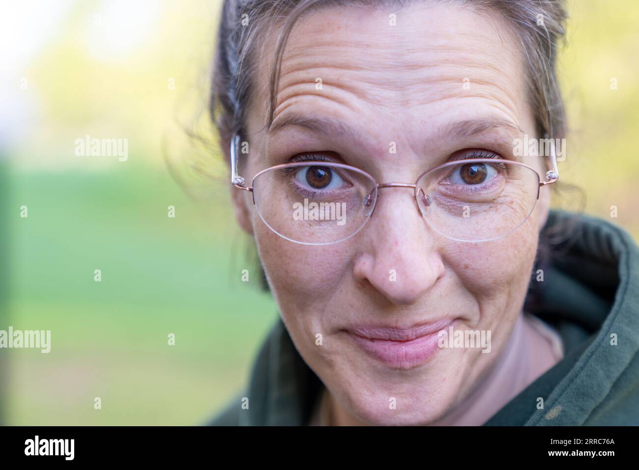 51 year old woman in a green hoodie Stock Photo - Alamy