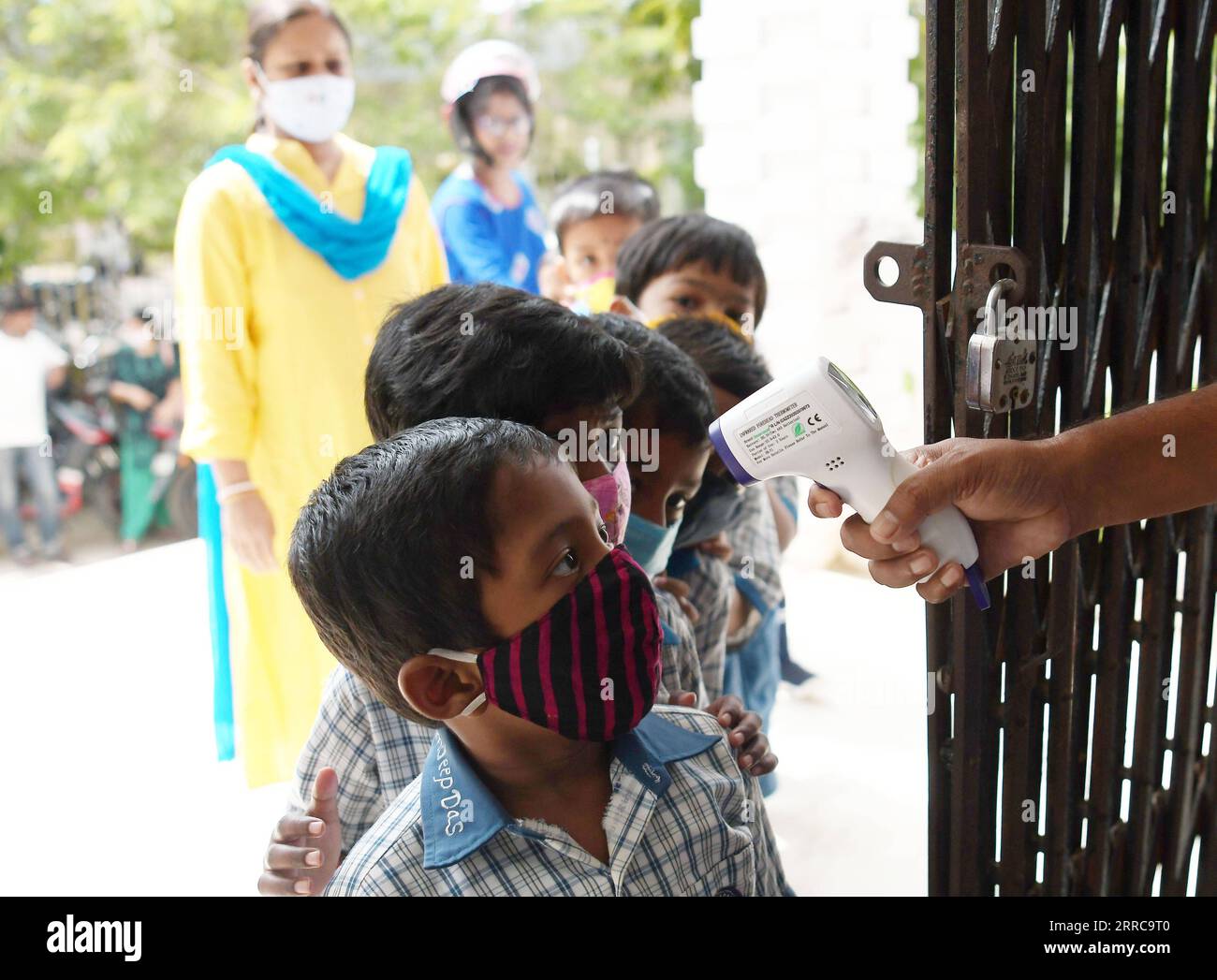 211028 -- AGARTALA, Oct. 28, 2021 -- A student takes a temperature check before entering the classroom on the first day of reopening of nursery sections in the schools after relaxation in COVID-19 restrictions in Agartala of Tripura, India, Oct. 28, 2021. Str/Xinhua INDIA-AGARTALA-OPENING OF NURSERY SECTIONS AbhisekxSaha PUBLICATIONxNOTxINxCHN Stock Photo