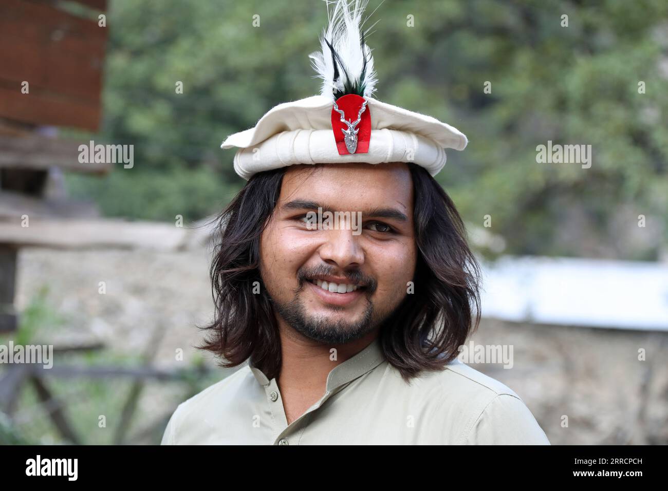 Chitrali man wearing a traditional pakol hat with the Markhor Insignia Stock Photo