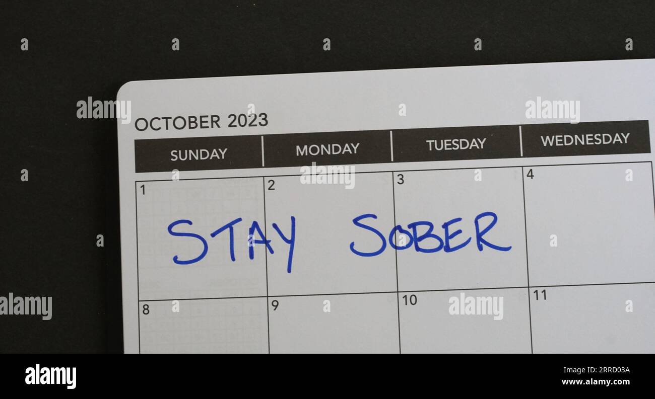 Sober October marked on a 2023 calendar. Like Dry January, Sober October involves cutting alcohol for the entire month, often for charity. Stock Photo