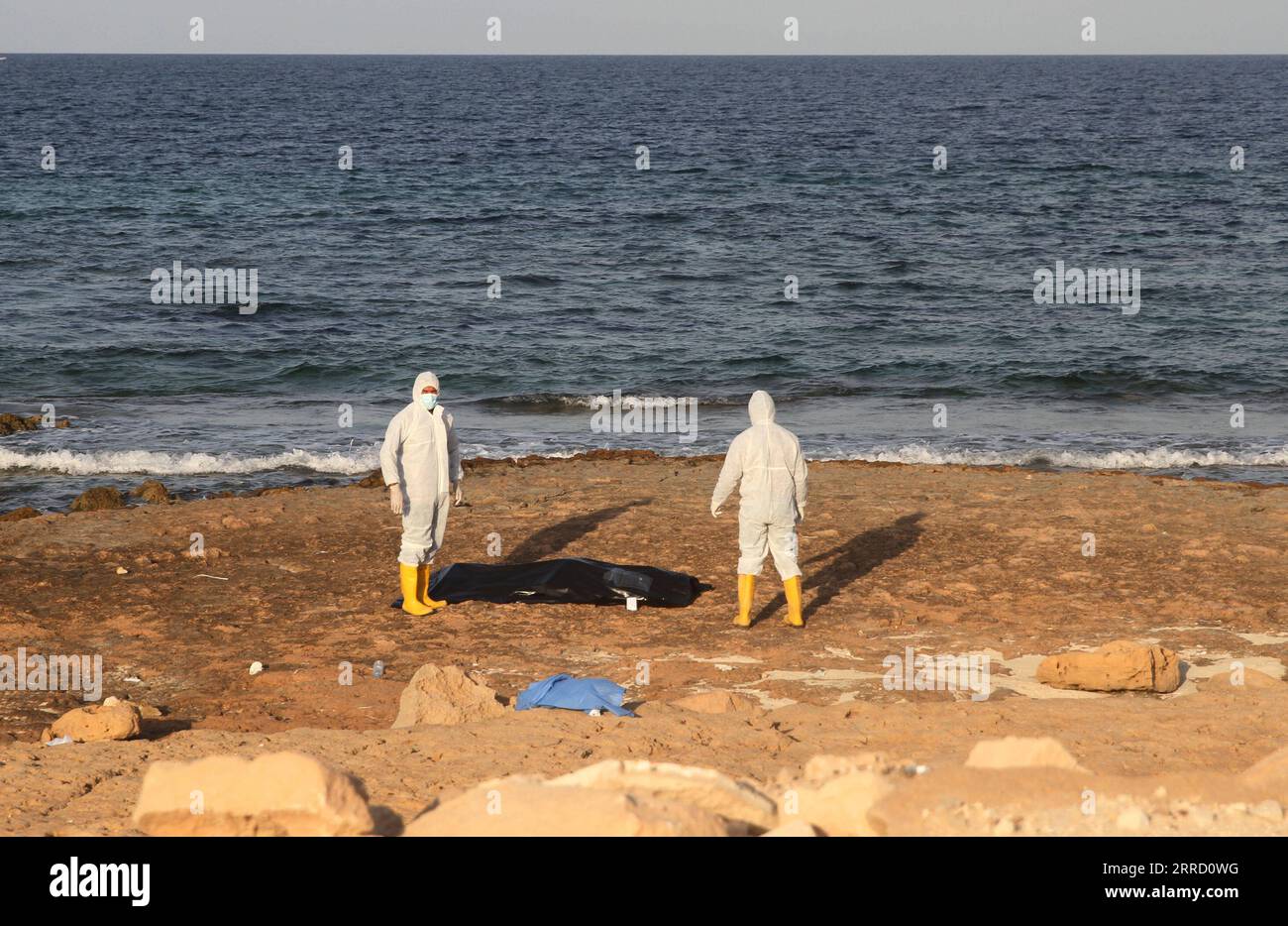 211126 -- TRIPOLI, Nov. 26, 2021 -- The Libyan Red Crescent staff exhume the body of illegal immigrant who drowned at sea off the coast of the western Libyan city of Sabratha, Nov. 25, 2021. The International Organization for Migration IOM on Nov. 20 said more than 75 illegal immigrants have drowned at sea off the coast of western Libya, while trying to reach Europe. Photo by /Xinhua LIBYA-SABRATHA-IMMIGRANTS-DROWNING HamzaxTurkia PUBLICATIONxNOTxINxCHN Stock Photo