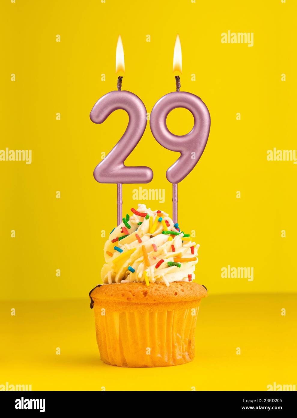 Birthday candle number 29 - Invitation card with yellow background Stock Photo