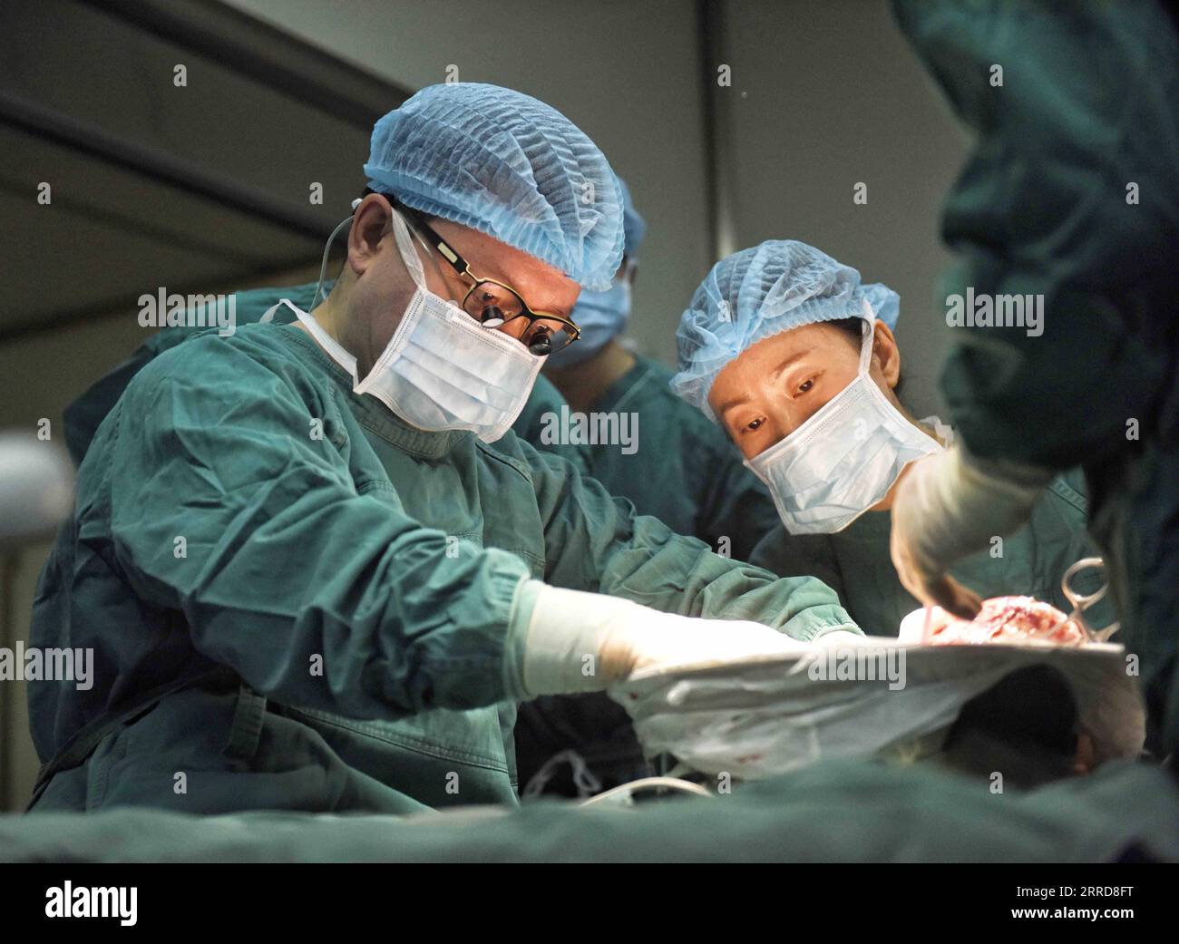 211210 -- CHENGDU, Dec. 10, 2021 -- Wang Wentao L uses the technology of extracorporeal hepatectomy plus liver autotransplantation in the treatment of a hydatid disease patient at a hospital in Tibetan Autonomous Prefecture of Garze, southwest China s Sichuan Province, Jan. 16, 2020. Wang Wentao, deputy director of the liver surgery department at West China Hospital of Sichuan University, started his work on the prevention and control of hydatid disease in Tibetan Autonomous Prefecture of Garze in 2006 when he learned that some local people suffer from hydatid disease during one of his free cl Stock Photo