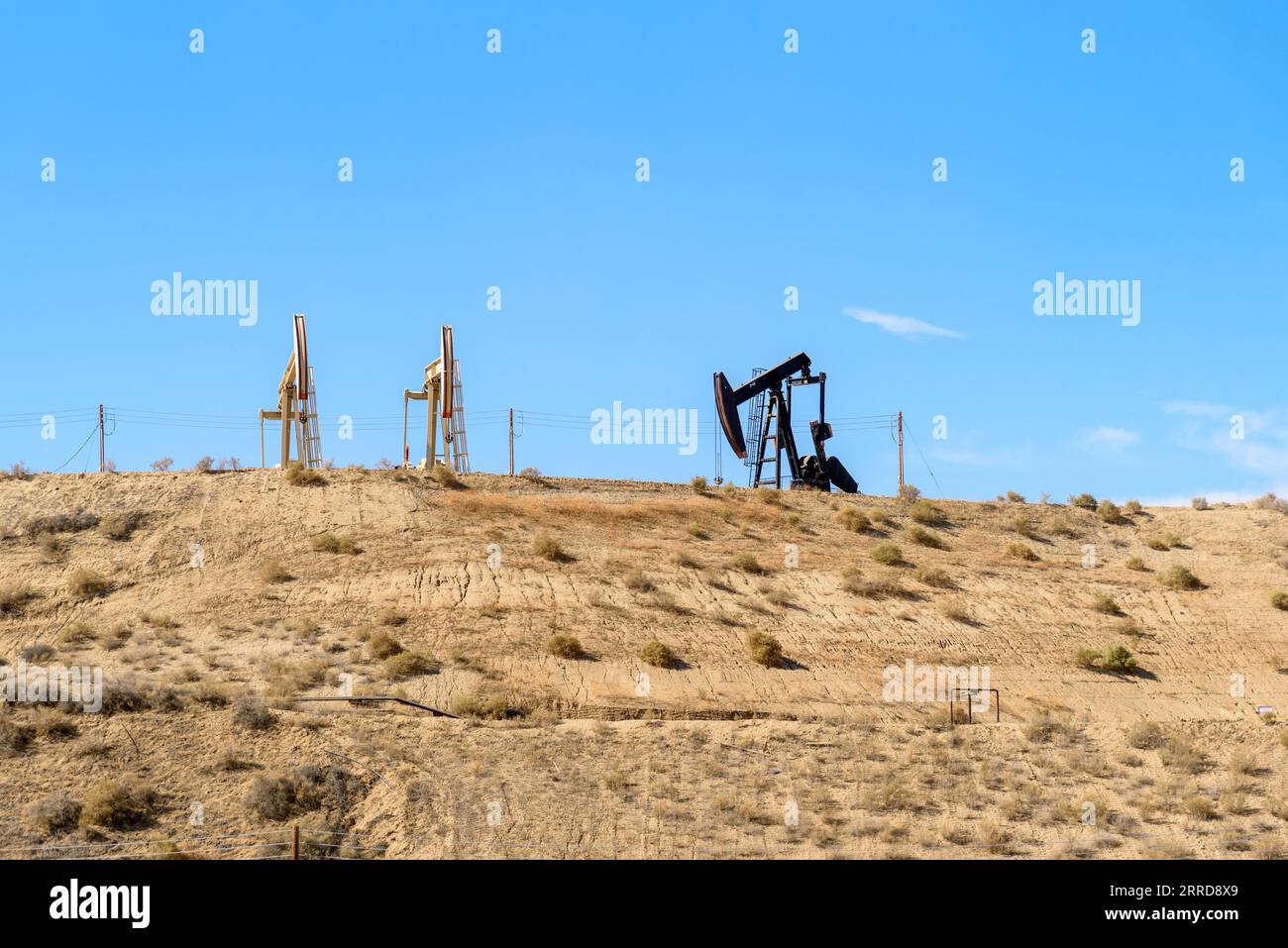 Oil wells on the top of a desert hill on a clear autumn day Stock Photo