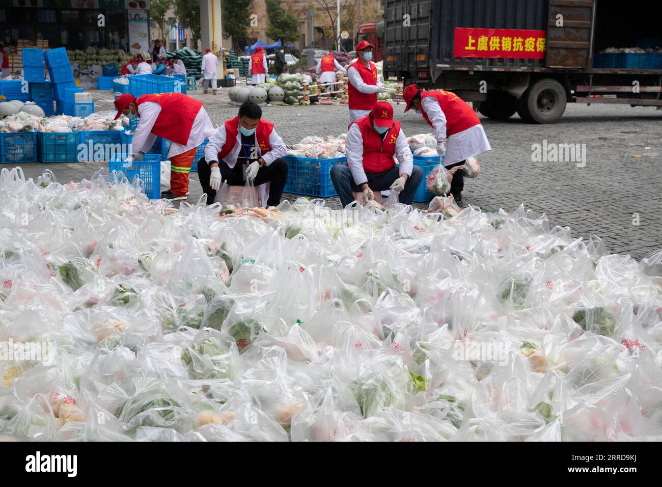 211212 -- SHANGYU, Dec. 12, 2021 -- Volunteers pack daily necessities for distribution to residents in Shangyu District of Shaoxing City, east China s Zhejiang Province, Dec. 12, 2021. East China s Zhejiang Province registered 138 locally-transmitted confirmed COVID-19 cases and one asymptomatic carrier between Dec. 5 and 3 p.m. Sunday, amid the latest COVID-19 resurgence. Of the total, 44 cases were reported in Ningbo, 77 cases and one asymptomatic carrier were in Shaoxing, and 17 cases were in the provincial capital of Hangzhou, said a provincial government press conference Sunday. Photo by Stock Photo