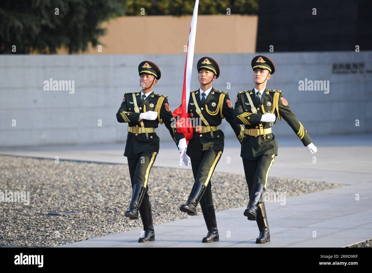 211213 -- NANJING, Dec. 13, 2021 -- The honor guard escorts the national flag ahead of the national memorial ceremony for the Nanjing Massacre victims at the Memorial Hall of the Victims of the Nanjing Massacre by Japanese Invaders in Nanjing, capital of east China s Jiangsu Province, Dec. 13, 2021.  CHINA-JIANGSU-NANJING MASSACRE VICTIMS-NATIONAL MEMORIAL CEREMONY CN JixChunpeng PUBLICATIONxNOTxINxCHN Stock Photo