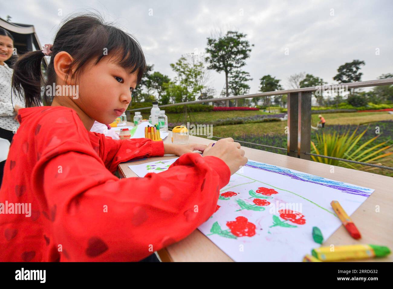 211223 -- GUANGZHOU, Dec. 23, 2021 -- A girl draws pictures while visiting Guangzhou Lijiao sewage treatment plant in Guangzhou, south China s Guangdong Province, Nov. 21, 2021. Traditional sewage treatment plants are being transformed into ecological underground sewage treatment plants in Guangzhou, to improve land utilization and tackle problems of secondary pollution. With the first underground sewage treatment plant in Guangzhou was built in 2009, the city has built and upgraded 9 such plants so far, with a daily sewage treatment capacity of 1.81 million tonnes. Sewage treatment facilities Stock Photo