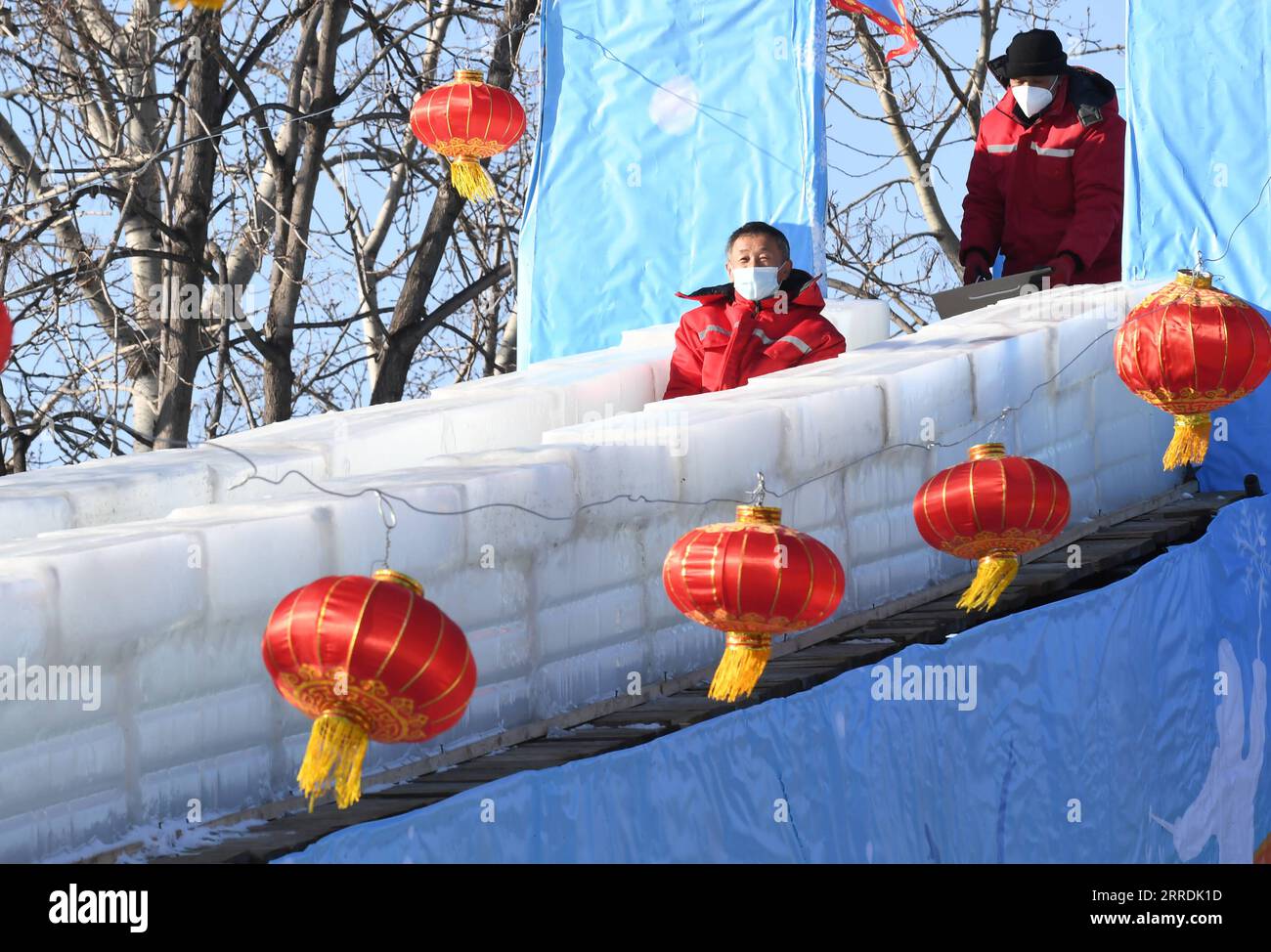 211230 -- BEIJING, Dec. 30, 2021 -- Staff members test an ice slide at Yuanmingyuan Park in Beijing, capital of China, Dec. 30, 2021. The Old Summer Palace, or Yuanmingyuan, announced on Thursday that it will hold a ice and snow festival which opens around New Year s day in 2022 and lasts until February to welcome the Beijing 2022 Winter Olympic Games.  CHINA-BEIJING-YUANMINGYUAN PARK-WINTER FUN CN LuoxXiaoguang PUBLICATIONxNOTxINxCHN Stock Photo