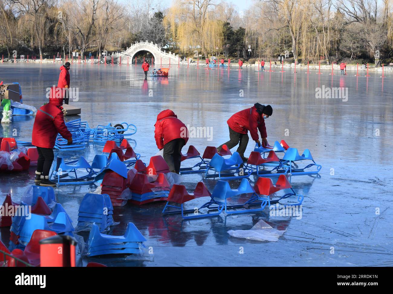 211230 -- BEIJING, Dec. 30, 2021 -- Staff members prepare sleds on a frozen lake at Yuanmingyuan Park in Beijing, capital of China, Dec. 30, 2021. The Old Summer Palace, or Yuanmingyuan, announced on Thursday that it will hold a ice and snow festival which opens around New Year s day in 2022 and lasts until February to welcome the Beijing 2022 Winter Olympic Games.  CHINA-BEIJING-YUANMINGYUAN PARK-WINTER FUN CN LuoxXiaoguang PUBLICATIONxNOTxINxCHN Stock Photo