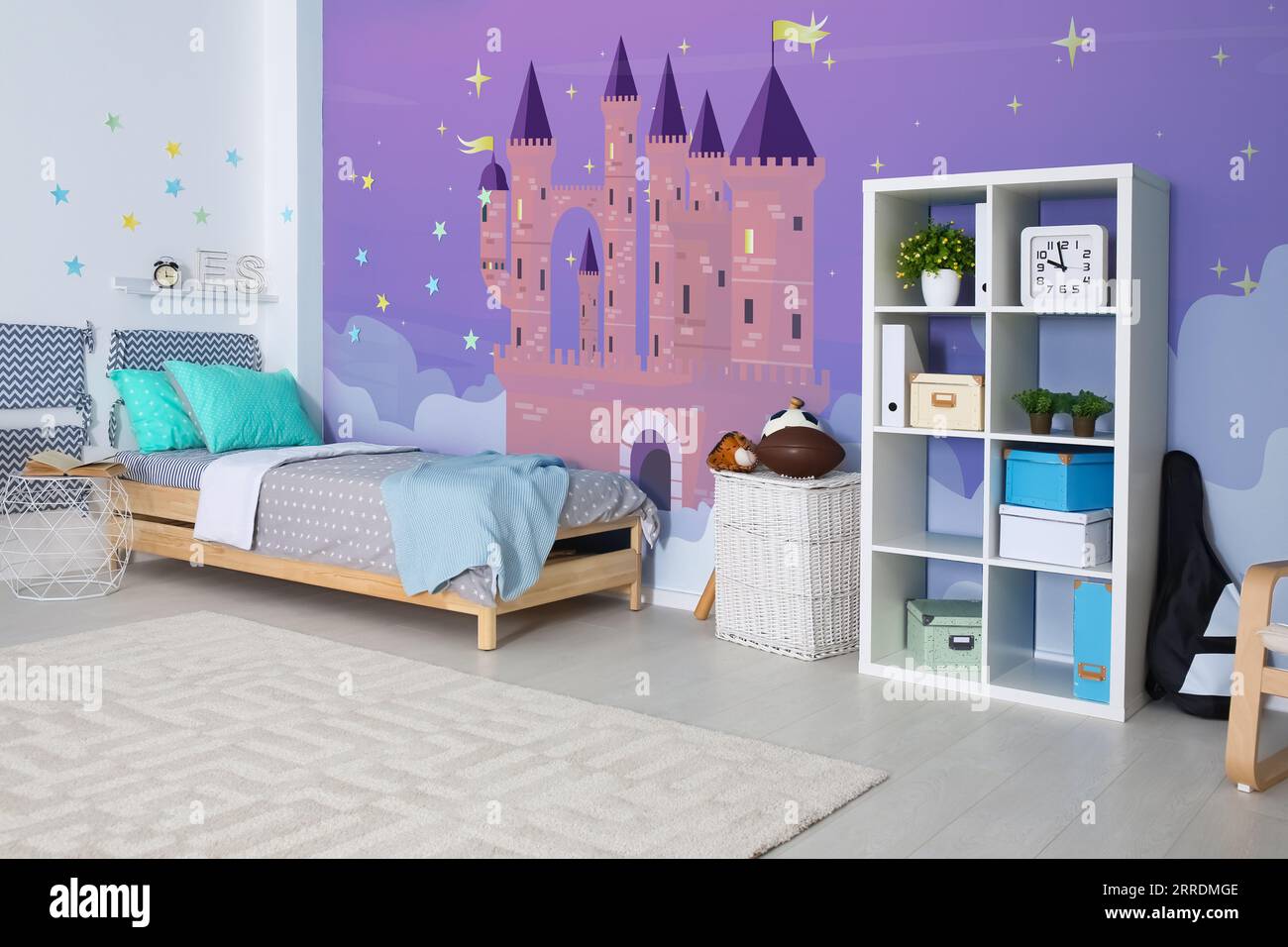 Kid’s room interior with comfortable bed. Fairytale themed wallpapers
