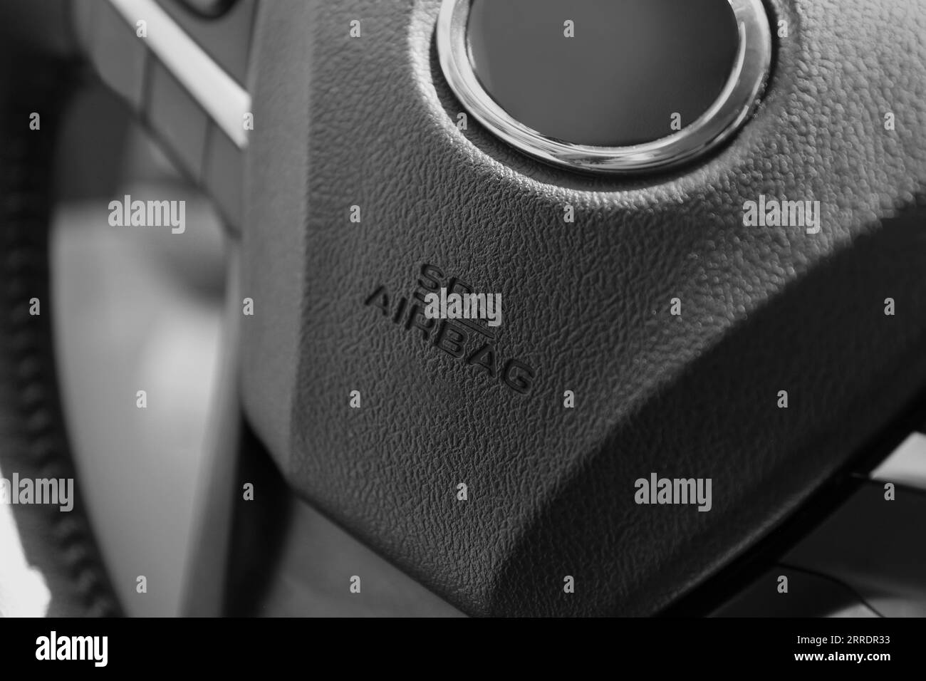 Safety airbag sign on steering wheel inside car, closeup Stock Photo