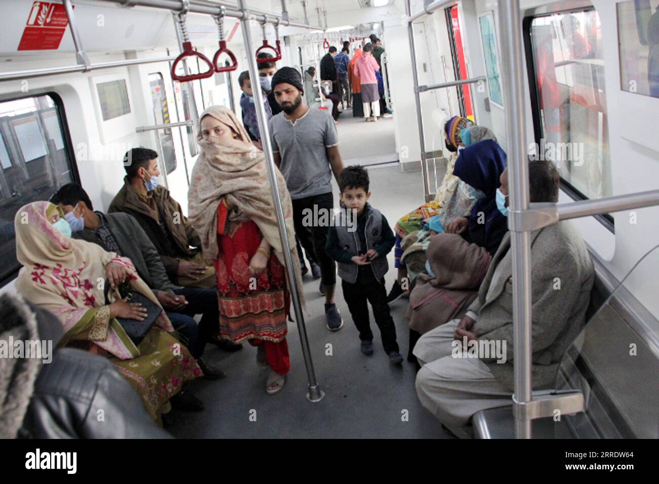 220109 -- LAHORE, Jan. 9, 2022 -- People take the Orange Line metro train in Lahore, Pakistan, Dec. 29, 2021. Officially open to traffic on Oct. 25, 2020, the eco-friendly Orange Line metro train is an early project under the China-Pakistan Economic Corridor CPEC, a flagship project of the China-proposed Belt and Road Initiative. TO GO WITH Feature: Lahore Orange Line, epitome of China-Pakistan friendship Photo by /Xinhua PAKISTAN-LAHORE-B&R-CPEC-ORANGE LINE METRO TRAIN JamilxAhmed PUBLICATIONxNOTxINxCHN Stock Photo