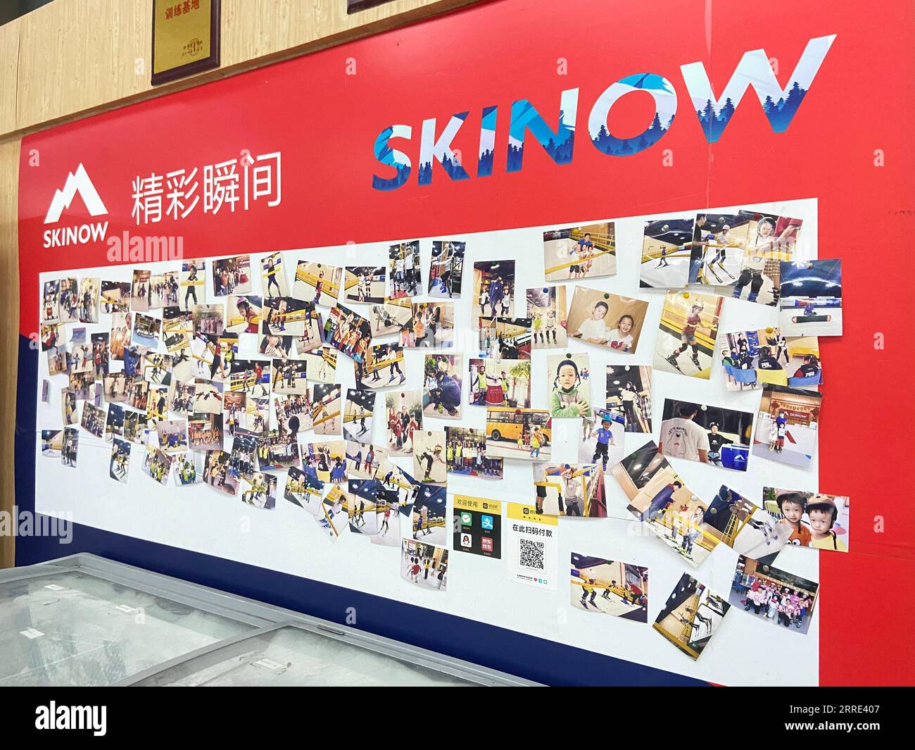 220125 -- HAIKOU, Jan. 25, 2022 -- Photos of learners are seen on a wall of an indoor skiing training field Skinow in Haikou, capital of south China s Hainan Province, Jan. 15, 2022. The Beijing 2022 Olympic Winter Games are scheduled from Feb. 4 to 20, followed by the Paralympics, and have stirred up passion for winter sports in China. Even people in China s warm areas, such as Hainan, have started participating in ice-snow sports. TO GO WITH China Focus: Passion for winter sports heats up on tropical island  CHINA-HAINAN-HAIKOU-WINTER SPORTS-HEAT CN ChenxZiwei PUBLICATIONxNOTxINxCHN Stock Photo