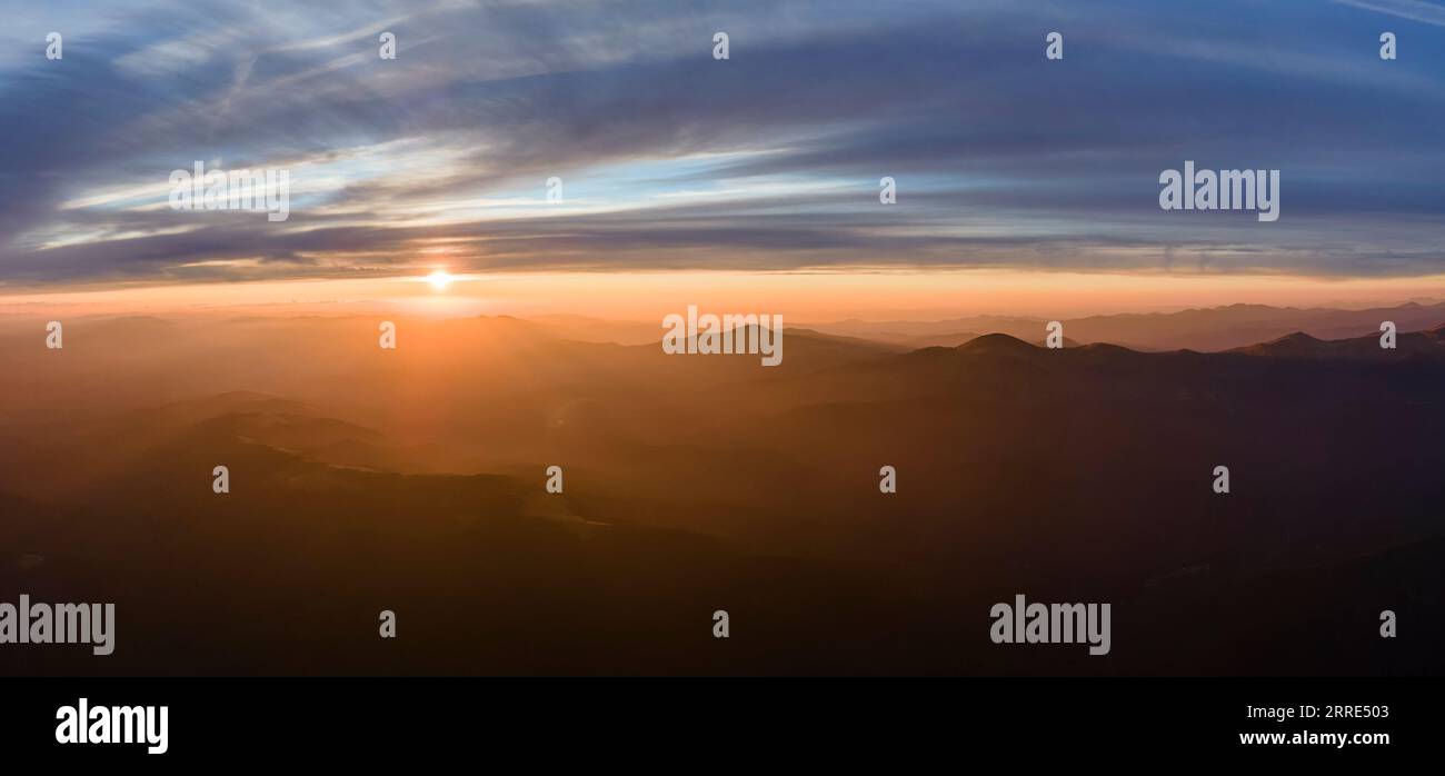 Beautiful mountain panoramic landscape with hazy peaks and foggy valley ...