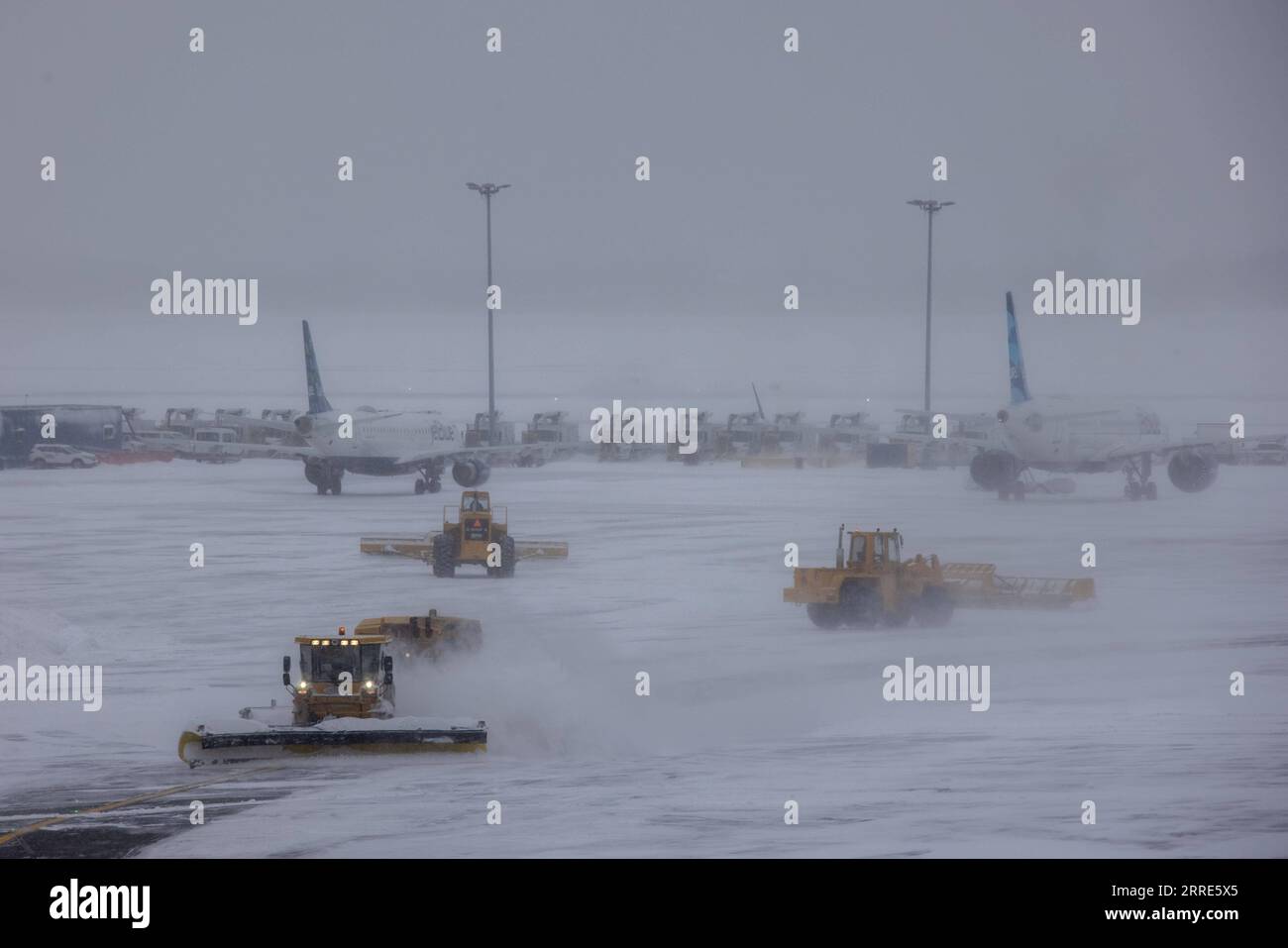 220130 -- NEW YORK, Jan. 30, 2022 -- Snow plows work at John F. Kennedy International Airport in New York, the United States, Jan. 29, 2022. Winter storm Kenan is bringing heavy snow and wind gusts to New York City and surrounding areas on Saturday. Snowfall at John F. Kennedy International Airport exceeded 5 inches in the last 12 hours, said a tweet from the National Weather Service at 9 a.m. on Saturday. As much as 460 flights from John F. Kennedy International Airport were canceled accounting for 80 percent of the total, according to travel information platform flightaware.com. Photo by /Xi Stock Photo