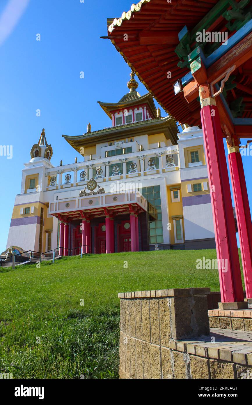 Buddhist temple Golden Abode of Buddha Shakyamuni against a blue sky with the alcove at the foreground. Elista, Kalmykia, Russia, copy space for text Stock Photo