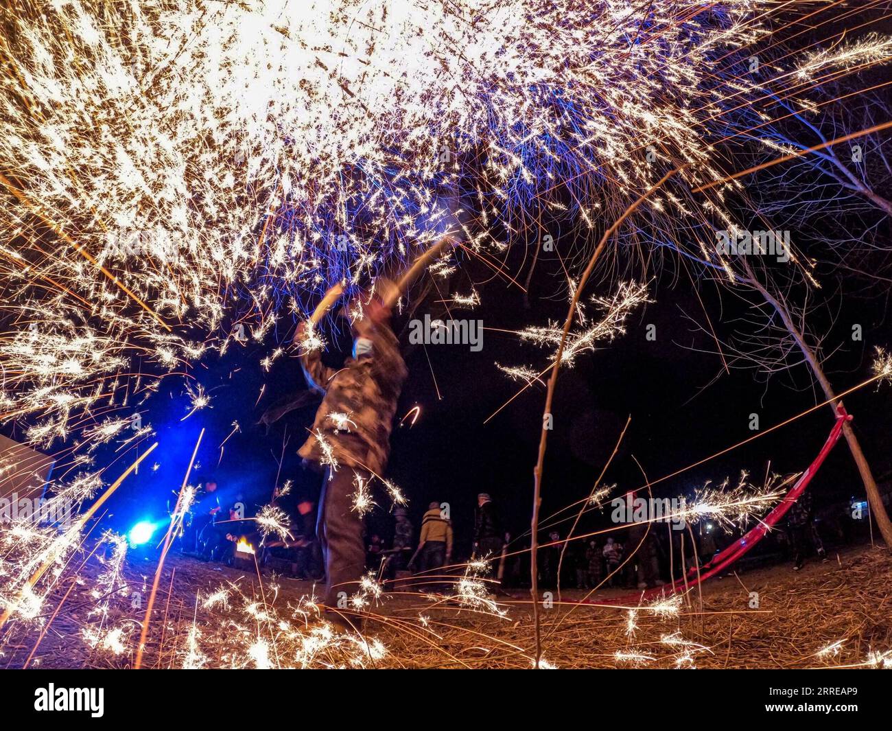 220215 -- BEIJING, Feb. 15, 2022 -- A villager throws molten iron to create fireworks to celebrate the Lantern Festival in Zoucheng, east China s Shandong Province, Feb. 14, 2022. The Lantern Festival, the 15th day of the first month of the Chinese lunar calendar, falls on Feb. 15 this year. Photo by /Xinhua CHINA-LANTERN FESTIVAL-CELEBRATION CN HanxJun PUBLICATIONxNOTxINxCHN Stock Photo