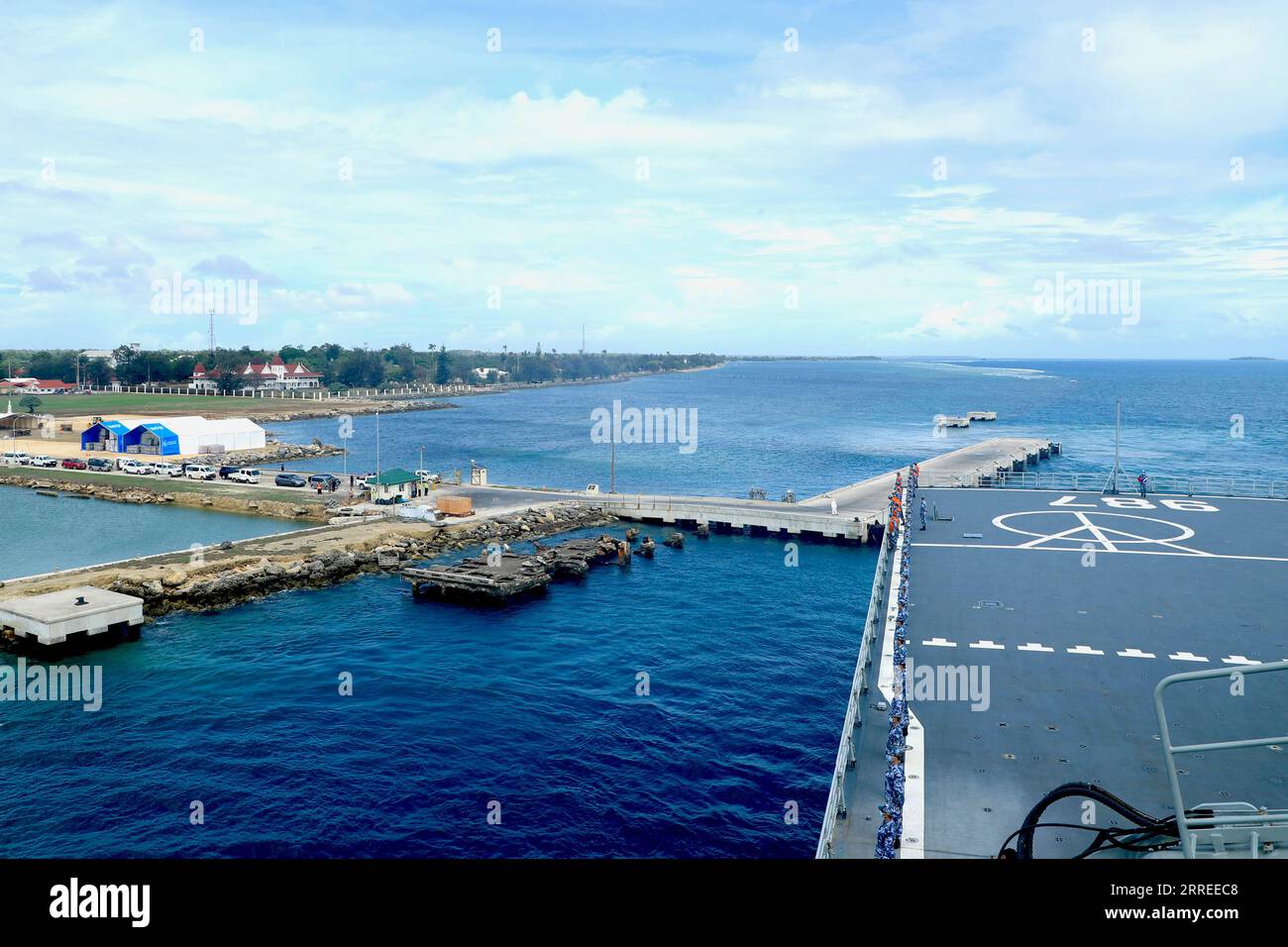 220224 -- NUKU ALOFA, Feb. 24, 2022 -- A ship of the Chinese People s Liberation Army PLA Navy departs from the port of Nuku alofa in Tonga, Feb. 23, 2022. The flotilla comprised of two ships of the PLA Navy departed the port of Nuku alofa on Wednesday after delivering China s disaster relief supplies to the South Pacific island nation of Tonga. Weighing approximately 1,400 tonnes, the latest supplies include mobile homes, tractors, electricity generators, water pumps, water purifiers, food and medical supplies. Photo by /Xinhua TONGA-CHINESE NAVY SHIPS-RELIEF SUPPLIES-DEPARTURE ZhouxYancheng Stock Photo