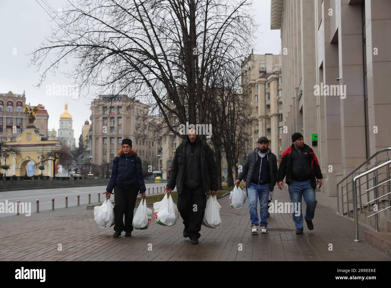 220224 -- KIEV, Feb. 24, 2022 -- Citizens walk on a street after buying daily necessities in Kiev, Ukraine, Feb. 24, 2022. Ukrainian President Volodymyr Zelensky said Thursday that Kiev decides to sever diplomatic relations with Moscow after Russia launched military operations in Donbass, the government-run Ukrinform news agency reported.  UKRAINE-KIEV-RUSSIA-DIPLOMATIC RELATIONS LixDongxu PUBLICATIONxNOTxINxCHN Stock Photo