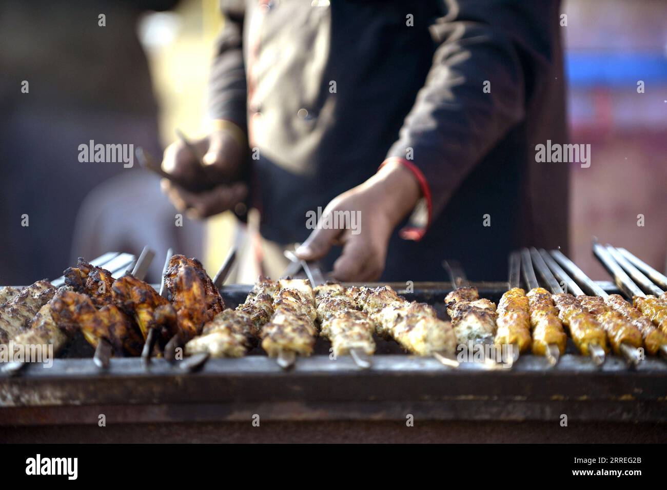 220227 -- ISLAMABAD, Feb. 27, 2022 -- A chef prepares food during Islamabad Eat food festival in Islamabad, capital of Pakistan, Feb. 26, 2022. Islamabad Eat, a famous food festival of the Pakistani capital, returned to the city in its true spirit, after a two-year absence induced by the outbreak of COVID-19, which halted many other excursion and sports activities in the country besides the festival.  PAKISTAN-ISLAMABAD-COVID-19-FOOD FESTIVAL AhmadxKamal PUBLICATIONxNOTxINxCHN Stock Photo